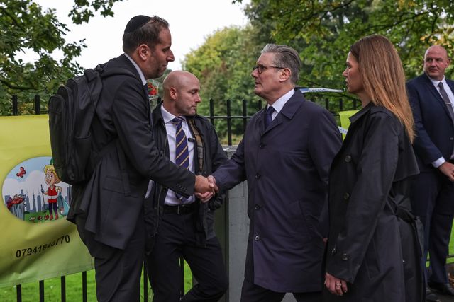 Victoria, Lady Starmer holds her husband Sir Keir Starmer, Prime Minister of the United Kingdom of Great Britain and Northern Ireland’s hand as he shakes hands with a member of the local community during the Manchester synagogue terror attack day 2 at Heaton Park Shul, Manchester, United Kingdom, 3rd October 2025

(Photo by Mark Cosgrove/News Images)