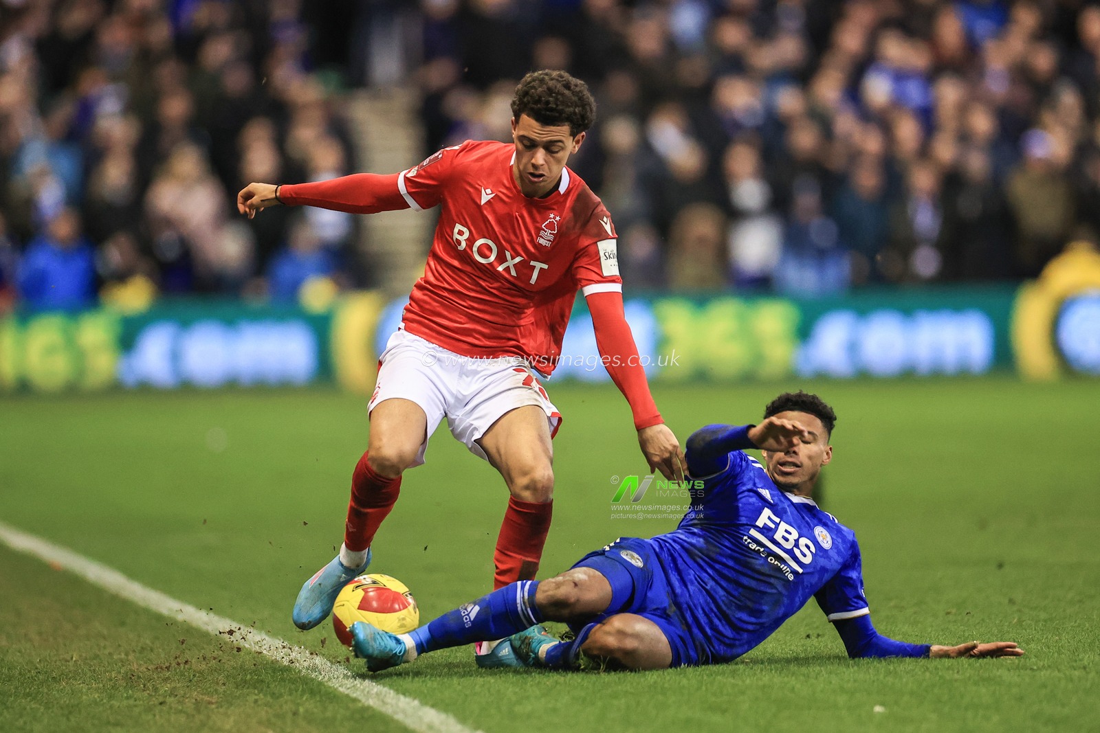 James Justin #2 of Leicester City  slides in to win the ball from Brennan Johnson #20 of Nottingham Forest