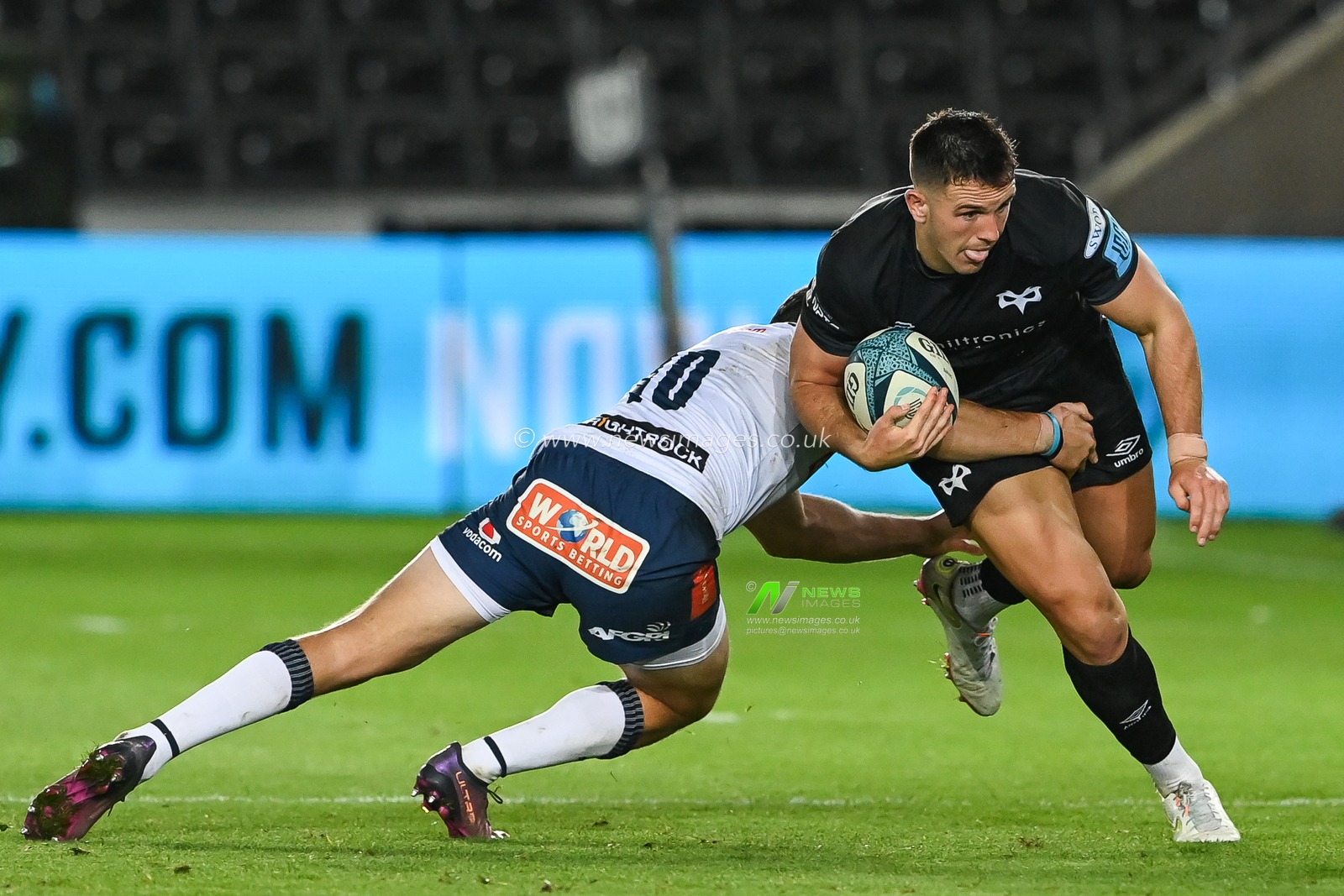 Owen Watkin of Ospreys is tackled by Chris Smith of Vodacom Bulls