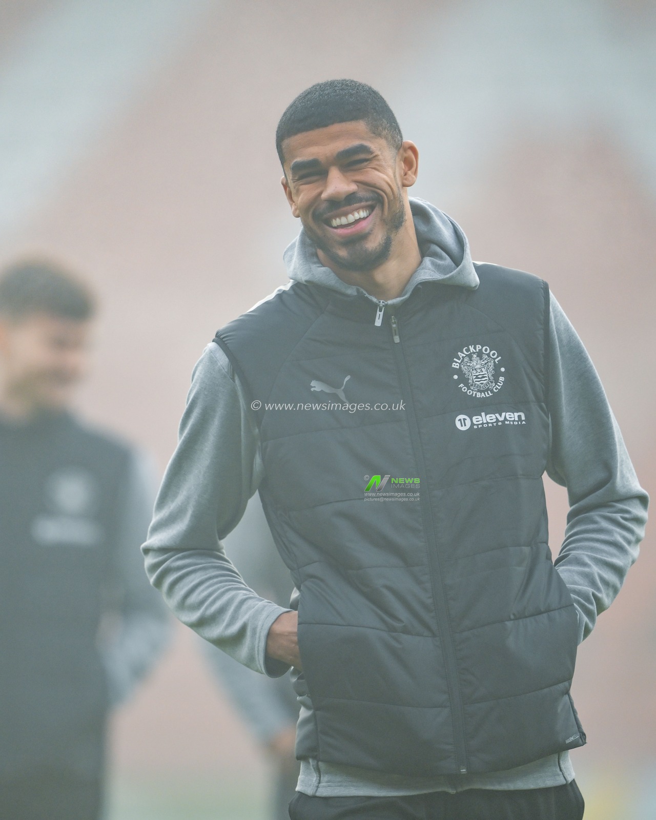 Ashley Fletcher of Blackpool is all smiles stands on the foggy pitch as he arrives ahead of the Sky Bet League 1 match Wrexham vs Blackpool at SToK Cae Ras, Wrexham, United Kingdom, 26th December 2024

(Photo by Craig Thomas/News Images)