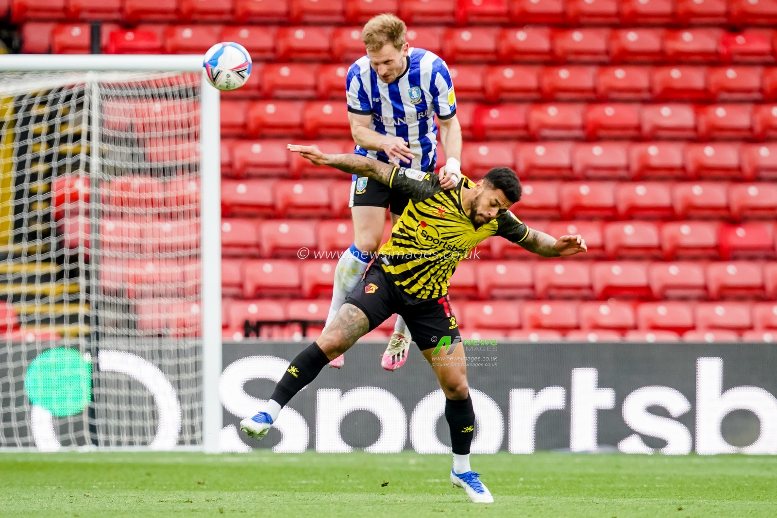 Tom Lees #15 of Sheffield Wednesday  battles with Andre Gray #18 of Watford