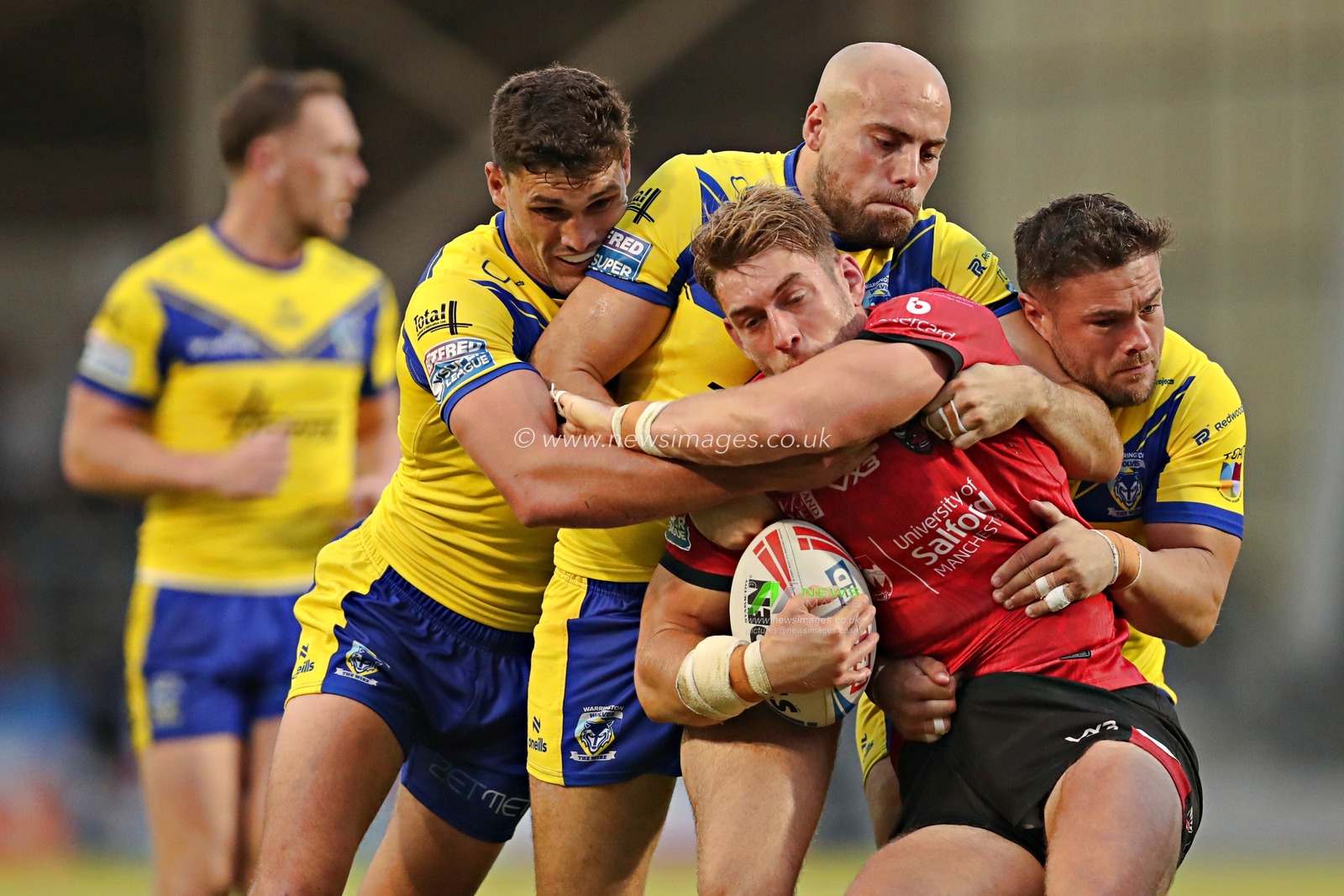 Sam Stone of Warrington Wolves, James Harrison of Warrington Wolves and Joe Philbin of Warrington Wolves tackle Jack Ormonroyd of Salford Red Devils during the Betfred Super League round 17 match Salford Red Devils vs Warrington Wolves at Salford Community Stadium, Eccles, United Kingdom, 4th July 2025(Photo by Sam Eaden/News Images)