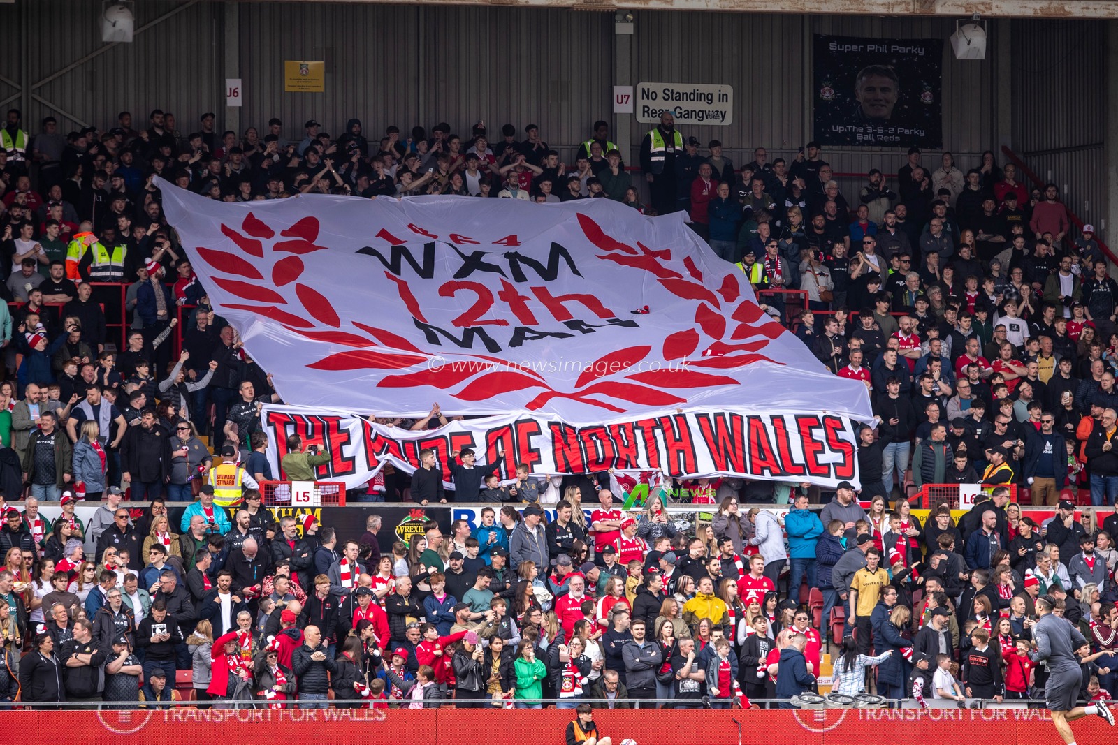 Wrexham fans hold up a 12th man banner during the Sky Bet League 1 match Wrexham vs Stockport County at SToK Cae Ras, Wrexham, United Kingdom, 22nd March 2025

(Photo by Nik Mesney/News Images)