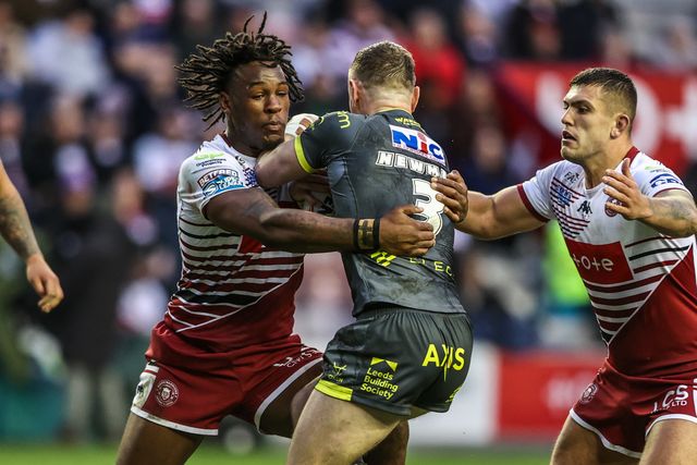 Harry Newman of Leeds Rhinos is tackled by Junior Nsemba of Wigan Warriors during the Betfred Super League round 11 match Wigan Warriors vs Leeds Rhinos at The Brick Community Stadium, Wigan, United Kingdom on 15 May 2026

(Photo by Alfie Cosgrove/News Images)