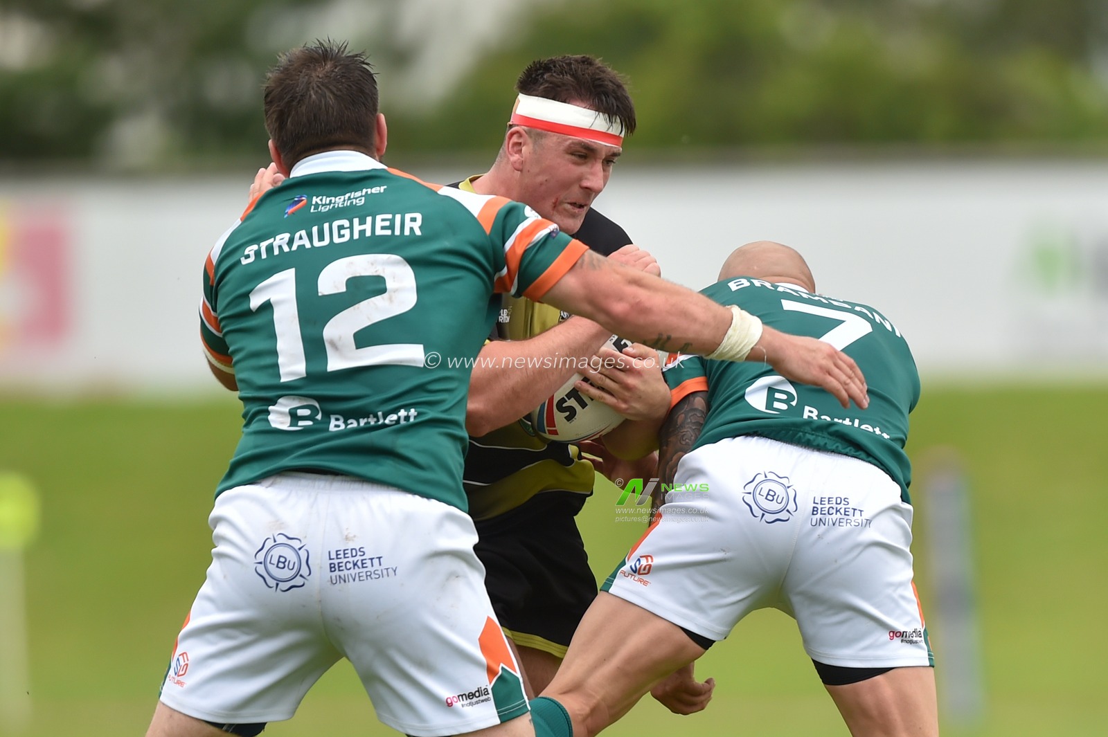 Gav Rodden of North Wales Crusaders in the tackle of Dominic Brambani (7) of Hunslet RLFC