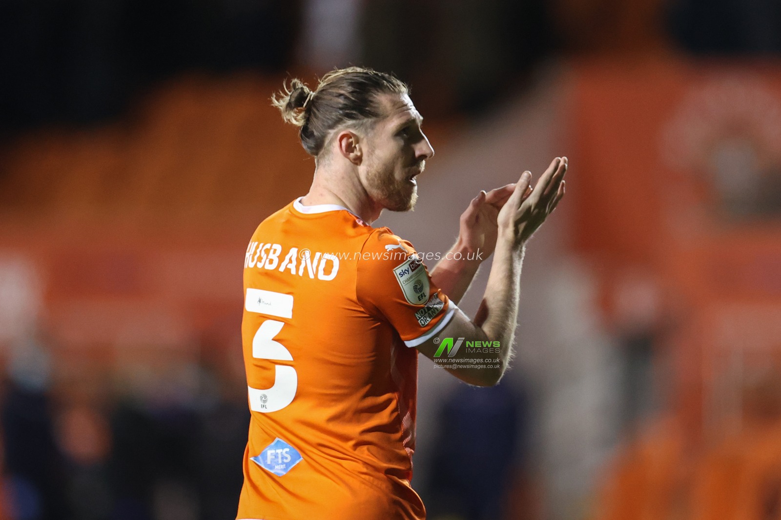 James Husband #3 of Blackpool applauds the fans