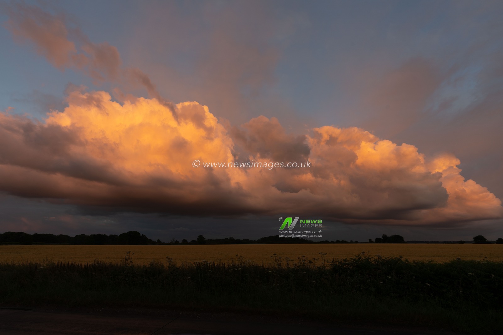 Storm clouds at the end of the day become part of the sunset.