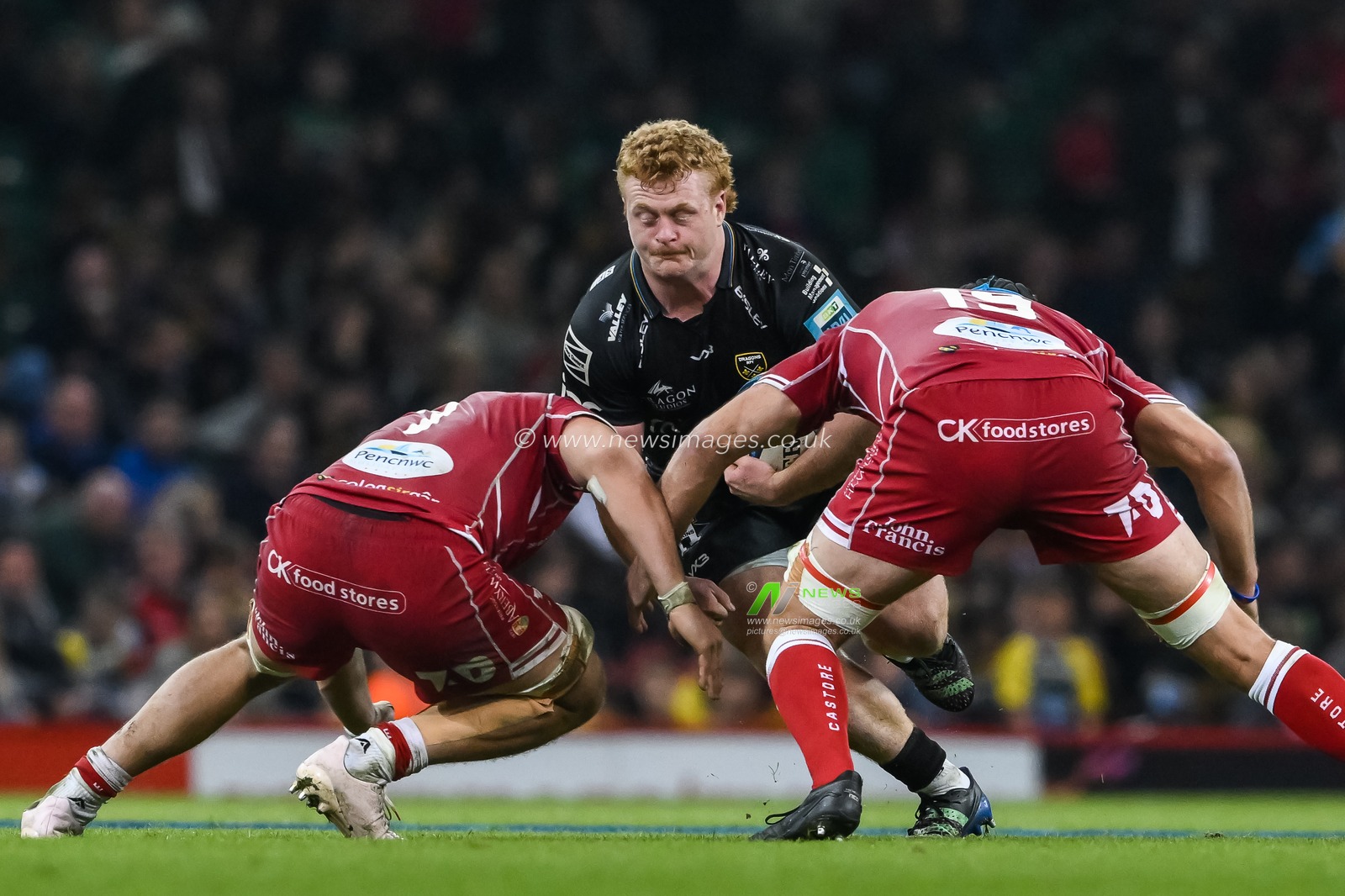 Bradley Roberts of the Dragonsis tackled by Kemsley Mathias and Josh Macleod of Scarlets during the United Rugby Championship match Dragons Rugby vs Llanelli Scarlets at Principality Stadium, Cardiff, United Kingdom, 22nd April 2023

(Photo by Craig Thomas/News Images)