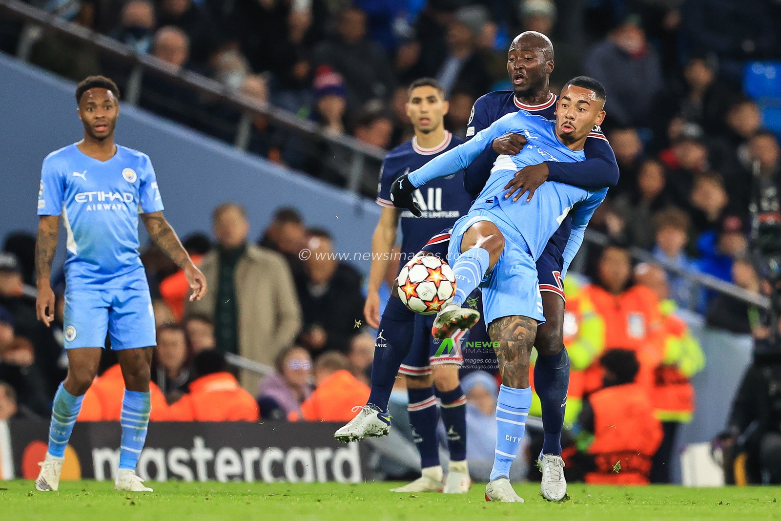 Gabriel Jesus #9 of Manchester City is held back by Danilo Pereira #15 of Paris Saint-Germain