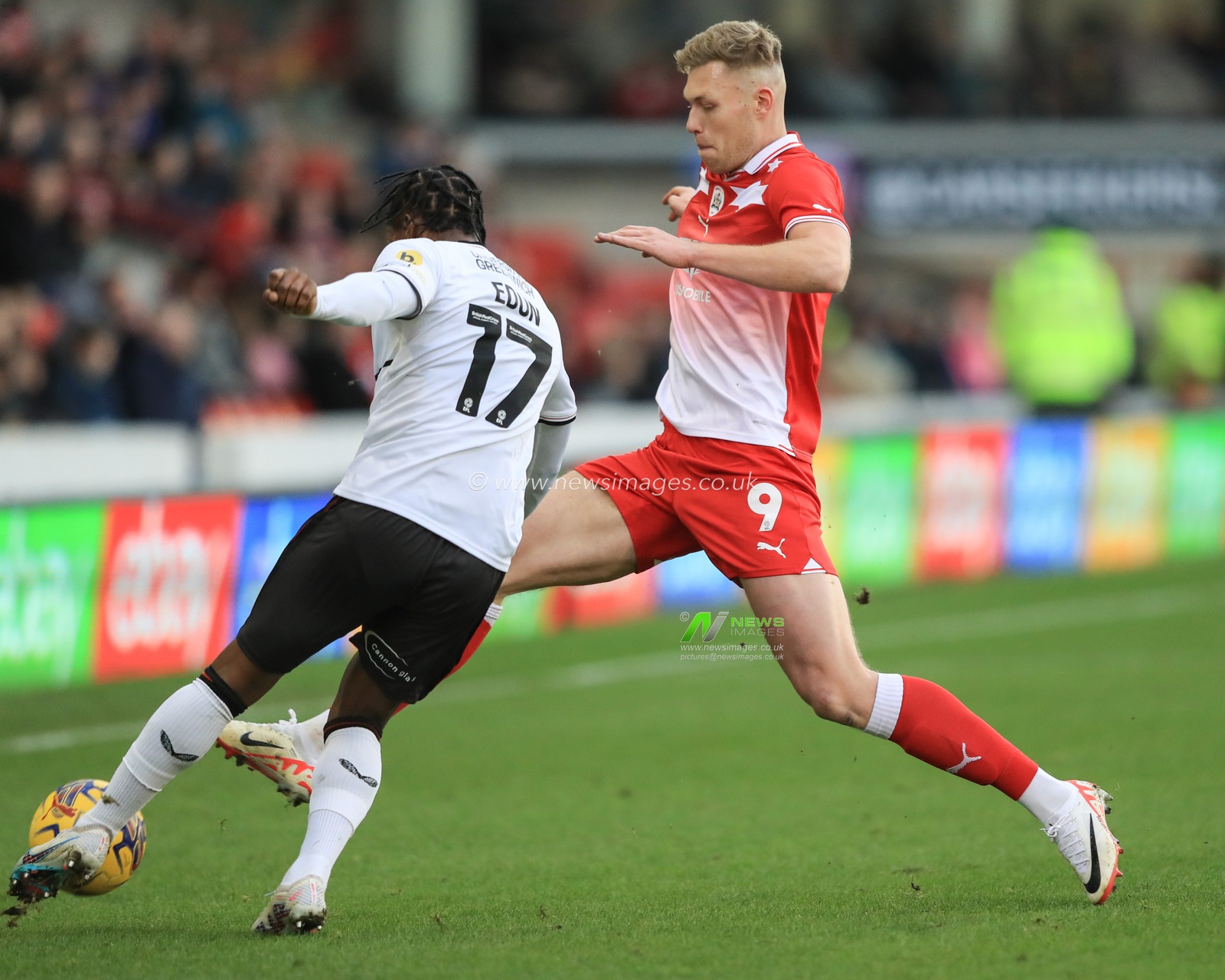 Sam Cosgrove #9 of Barnsley makes a tackle on Tayo Edun #17 of Charlton Athletic during the Sky Bet League 1 match Barnsley vs Charlton Athletic at Oakwell, Barnsley, United Kingdom, 16th December 2023

(Photo by Alfie Cosgrove/News Images)