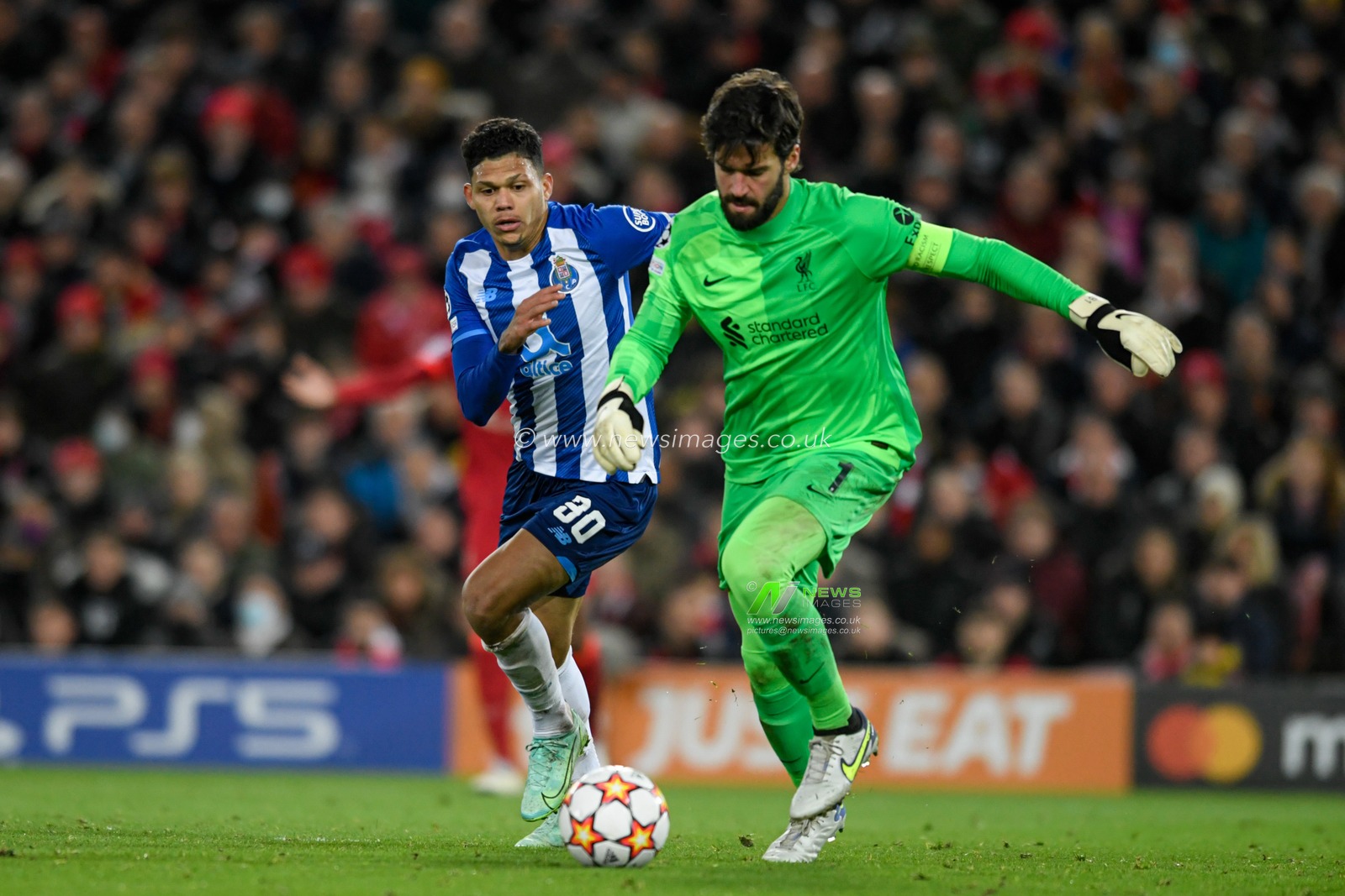 Evanilson #30 of FC Porto puts Alisson Becker #1 of Liverpool under pressure