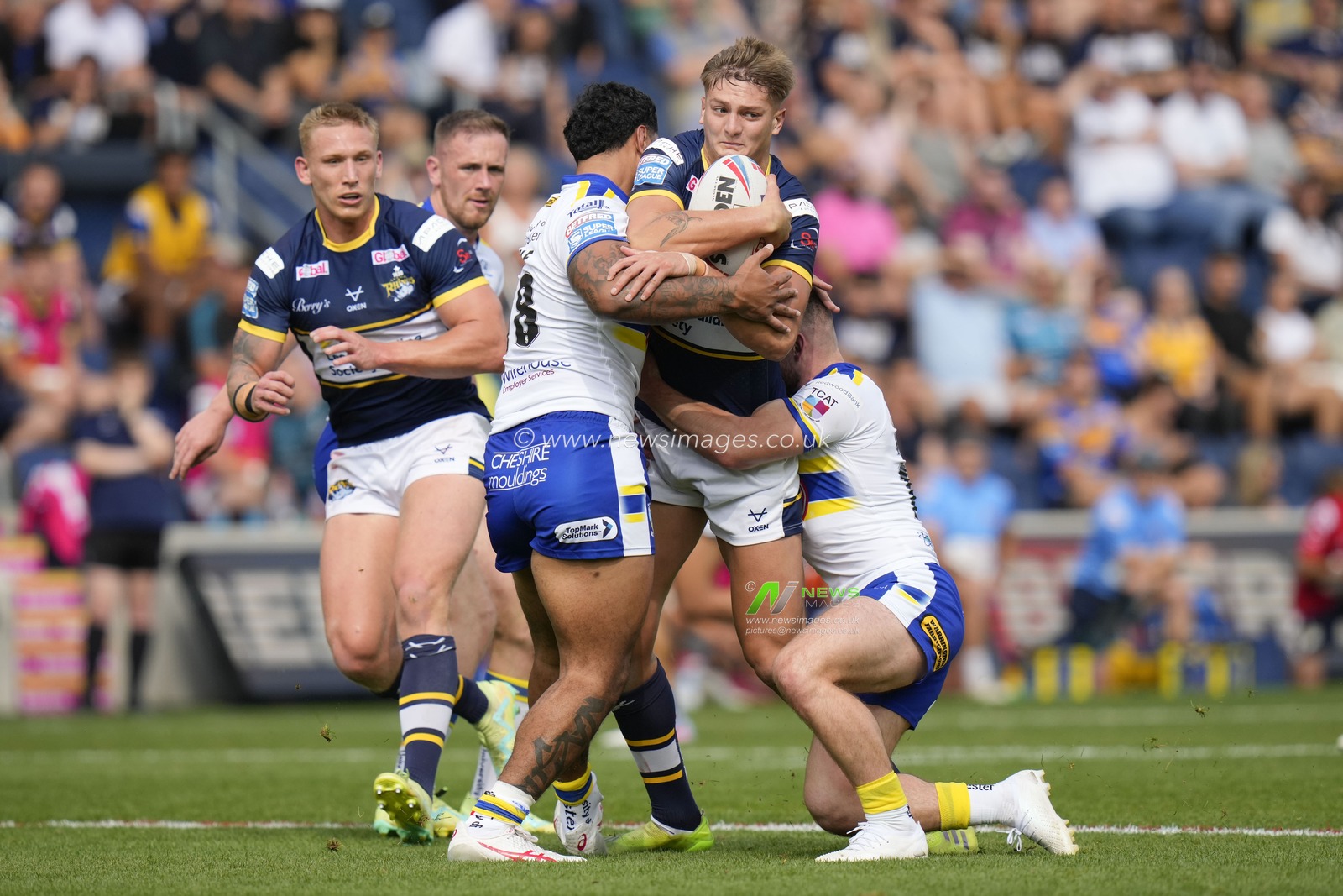 Sam Walters #22 of Leeds Rhinos is held in the tackle  during the Betfred Super League Round 22 match Leeds Rhinos vs Warrington Wolves at Headingley Stadium, Leeds, United Kingdom, 20th August 2023

(Photo by Steve Flynn/News Images)