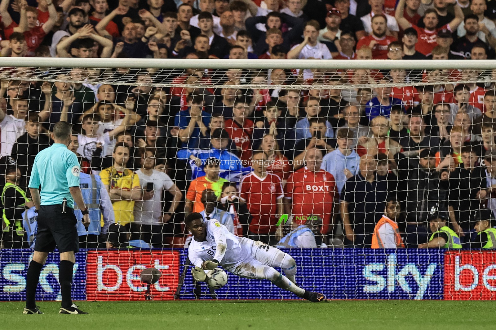 Brice Samba #30 of Nottingham Forest saves a penalty from Morgan Gibbs-White #27 of Sheffield United to put Forest through to Wembley