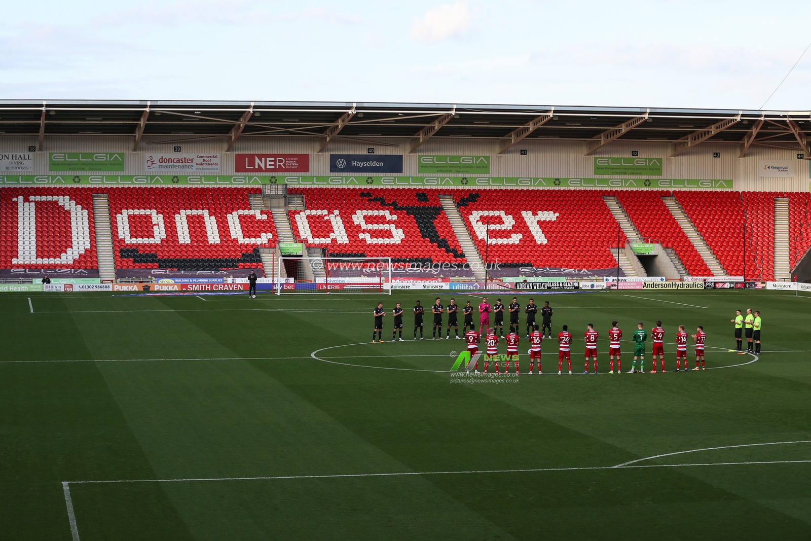 Players hold a minutes applause before the game in rememberance of Nobby Stiles
