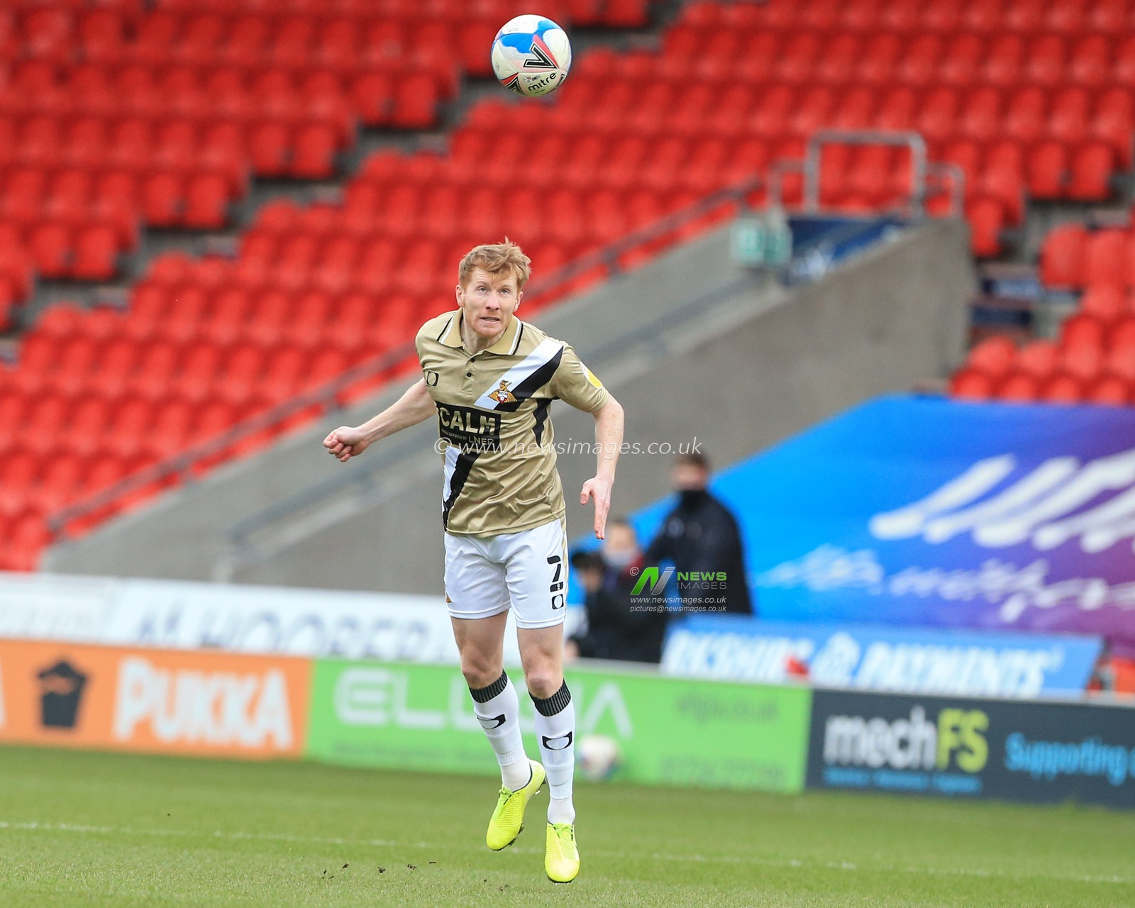 Brad Halliday #2 of Doncaster Rovers heads the ball back