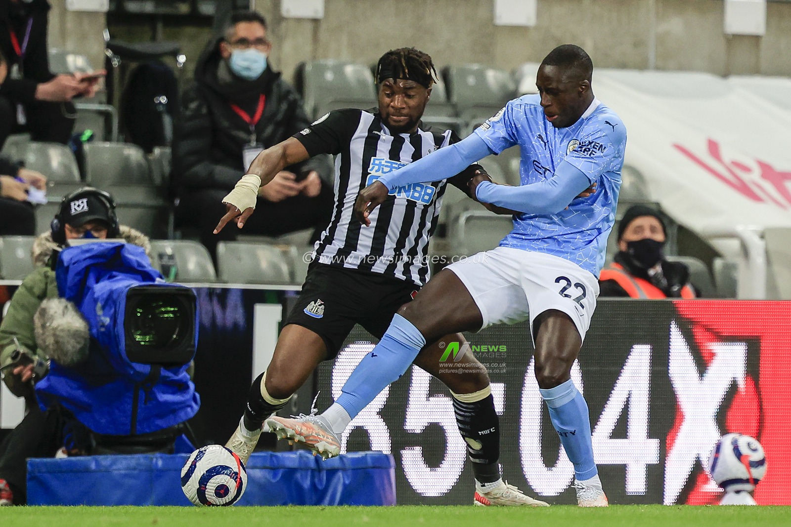 Benjamin Mendy #22 of Manchester City and Allan Saint-Maximin #10 of Newcastle United fight for possession of the ball