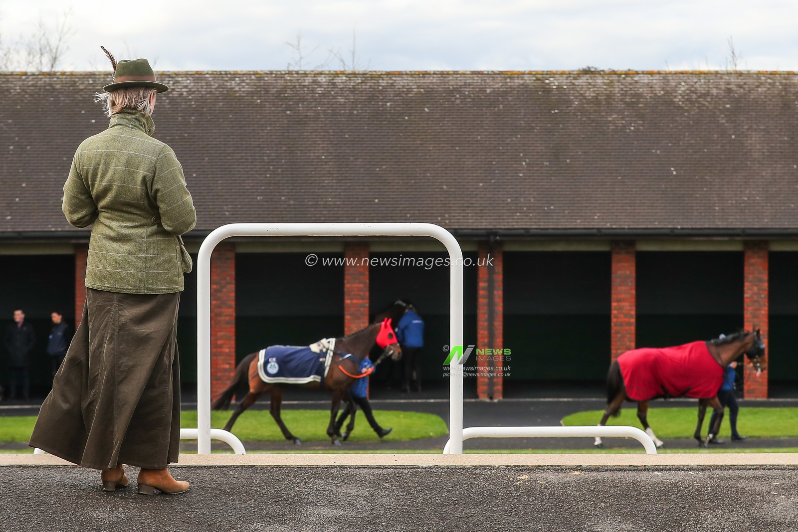 A racegoer watches the horses paraded infront of the stables during the Cheltenham Festival 2025 Style Wednesday at Cheltenham Racecourse, Cheltenham, United Kingdom, 12th March 2025

(Photo by Gareth Evans/News Images)