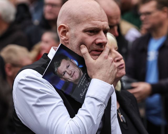 A mourner holds his face and the order of service book with a picture of Richard John Hatton MBE on the front during Ricky Hatton' Funeral at Manchester Cathedral, Manchester, United Kingdom, 10th October 2025

(Photo by Mark Cosgrove/News Images)