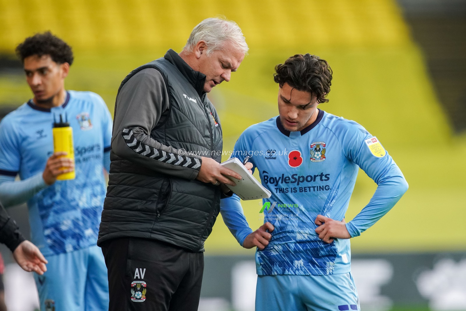 Coventry City assistant manager Adi Viveash gives instructions to Callum OHare #11 of Coventry City during a water break