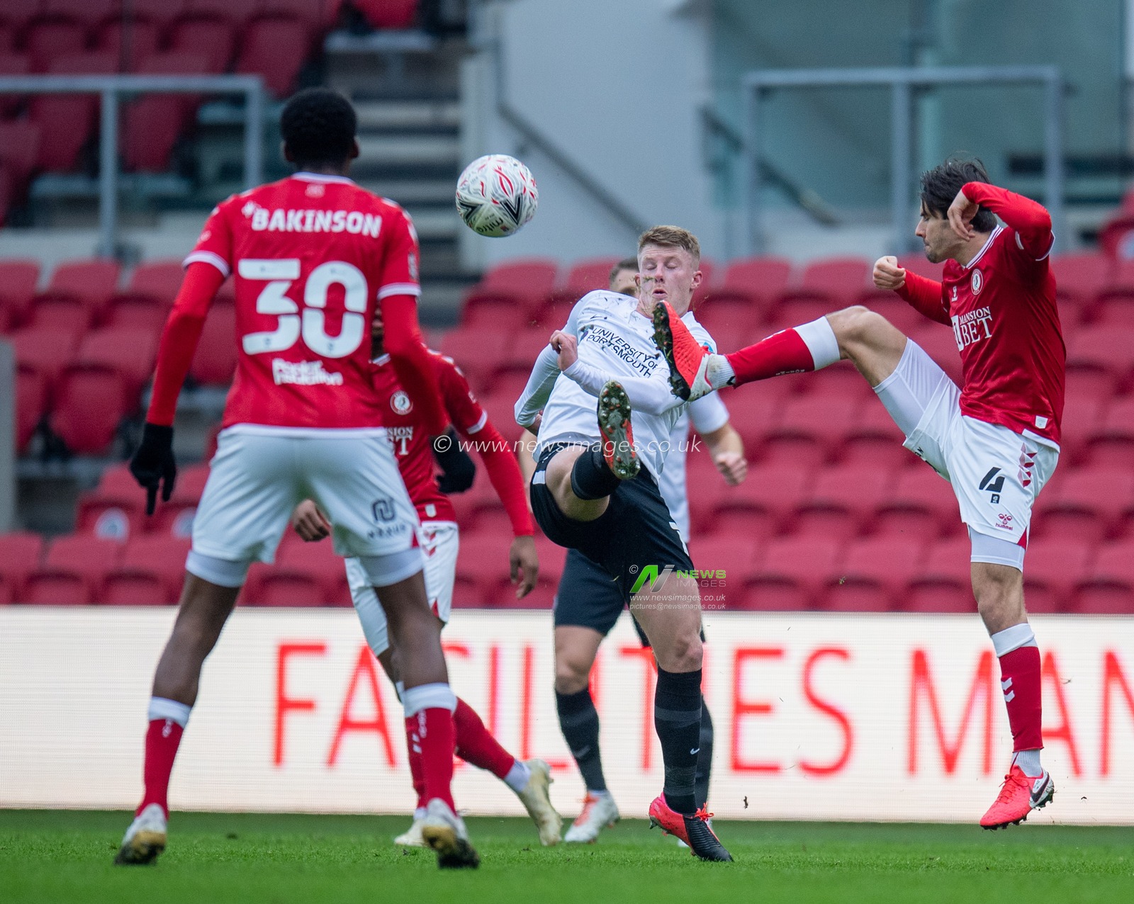 Ãdam Nagy #4 of Bristol City and Andy Cannon #14 of Portsmouth both challenge for the ball in the air