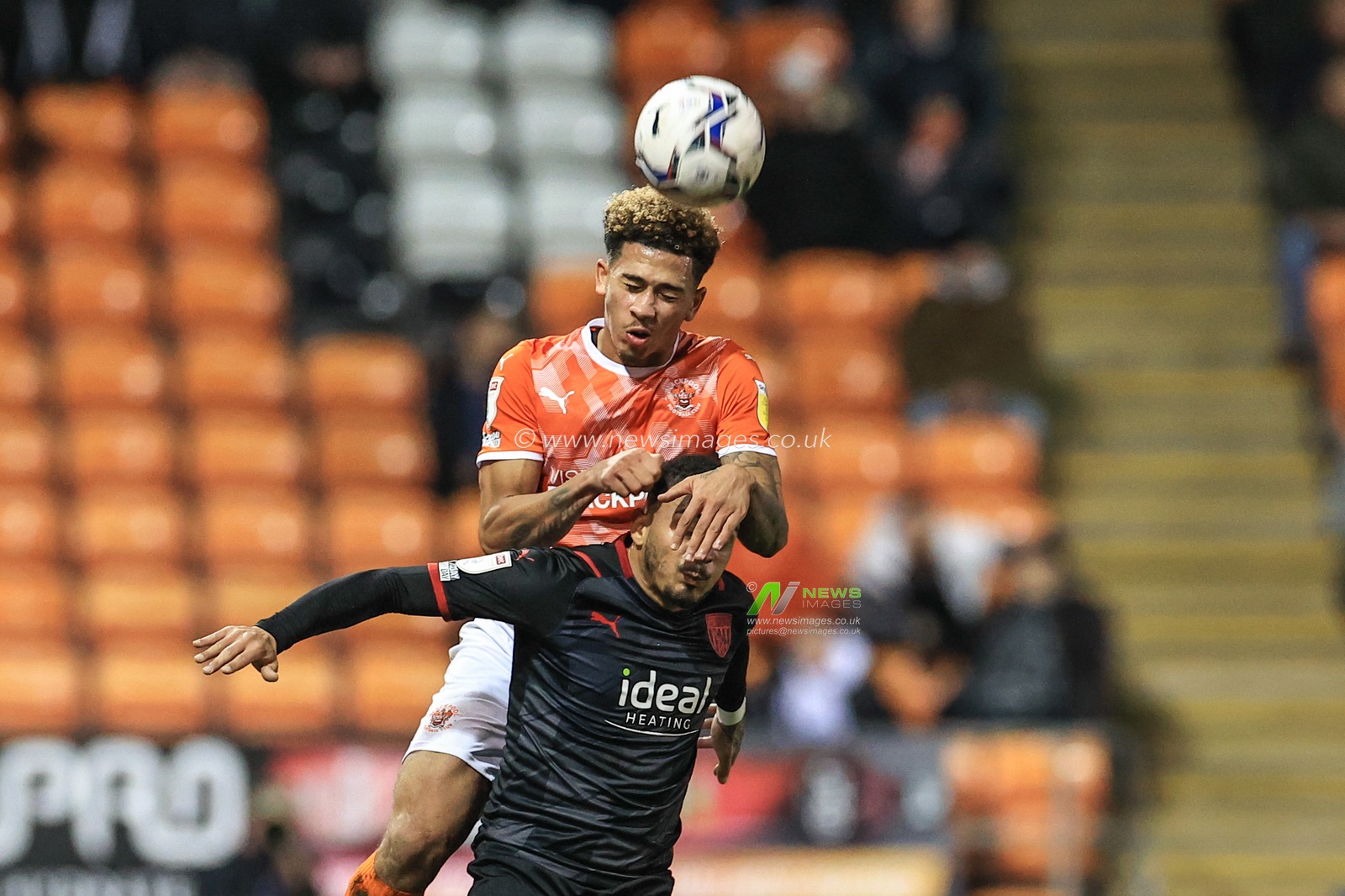 Jordan Gabriel #4 of Blackpool wins the high-ball from Karlan Grant #18 of West Bromwich Albion
