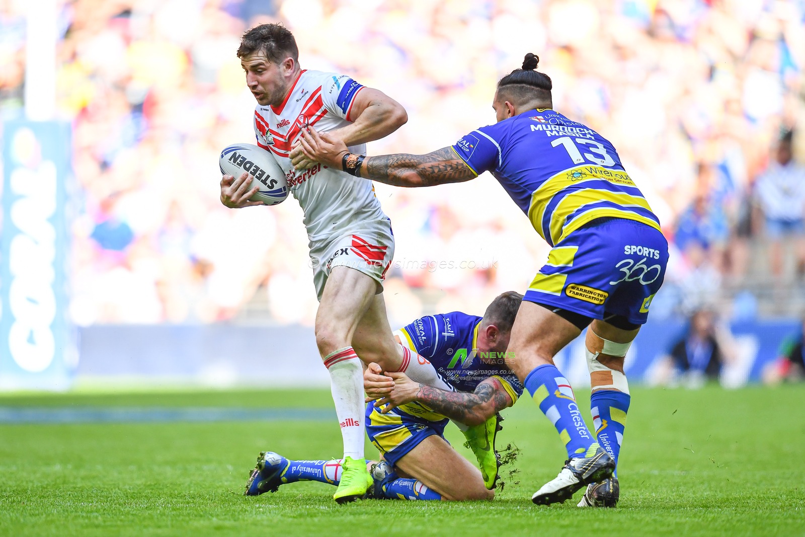 24th August 2019 , Wembley Stadium, London England ; 2019 Coral Challenge Cup Final ; St Helens vs Warrington Wolves ; Mark Percival (4) of St Helens is tackled by Daryl Clark of Warrington Wolves 



Credit: Craig Thomas/News Images