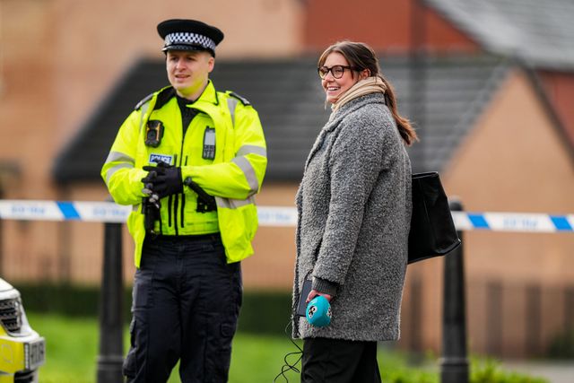 A police officer speaks to a journalist outside a cordon in Derby, during a Major Explosives Incident in Derby that began on Thursday December 4 when police executed a warrant at an address on Vulcan Street, Derby, that saw two men arrested on suspicion of explosives offences and 200 homes evacuated (Maynard Manyowa / News Images)