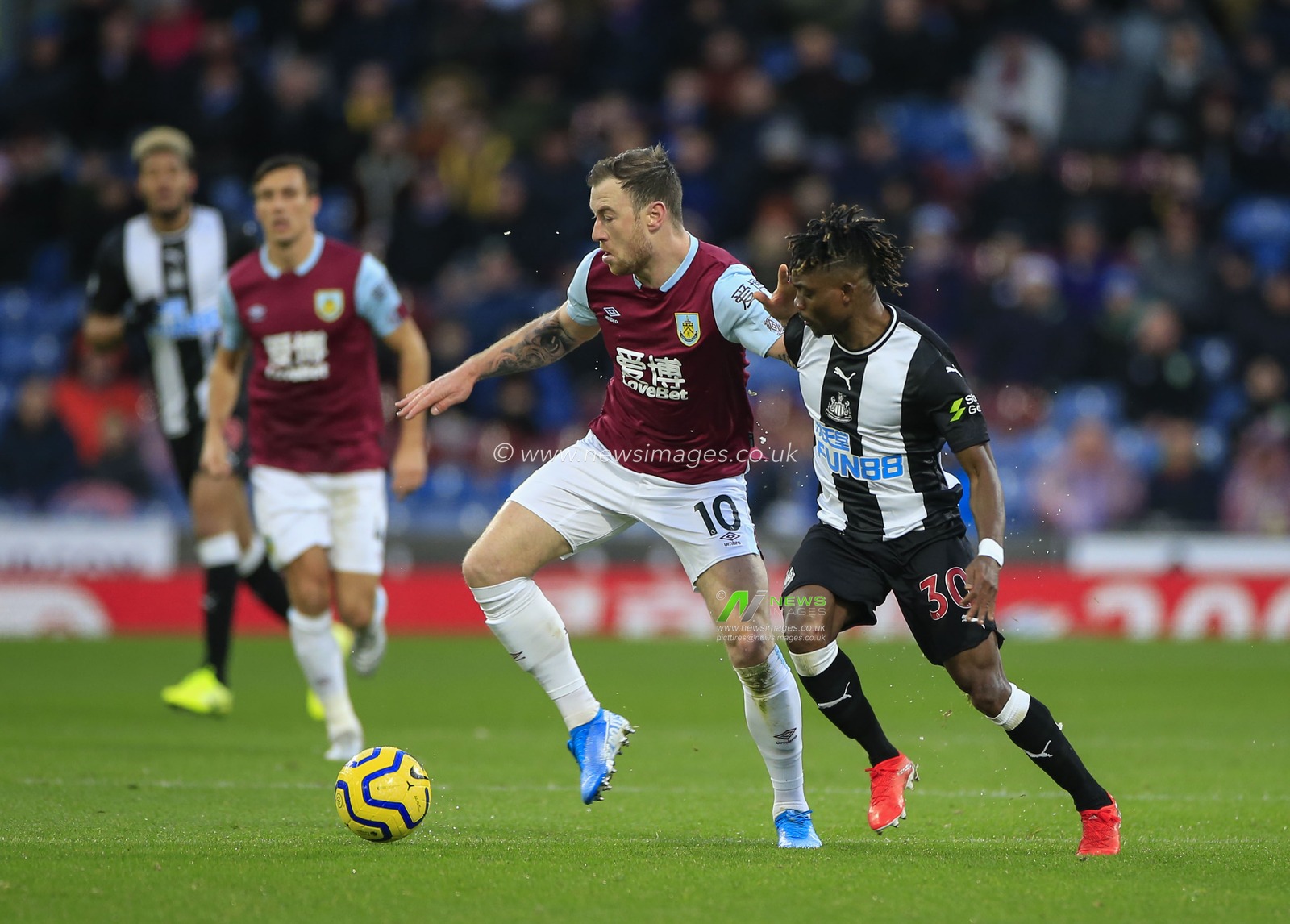 14th December 2019, Turf Moor, Burnley, England; Premier League, Burnley v Newcastle United : Ashley Barnes (10) of Burnley shields the ball from Christian Atsu (30) of Newcastle United

Credit: Conor Molloy/News Images