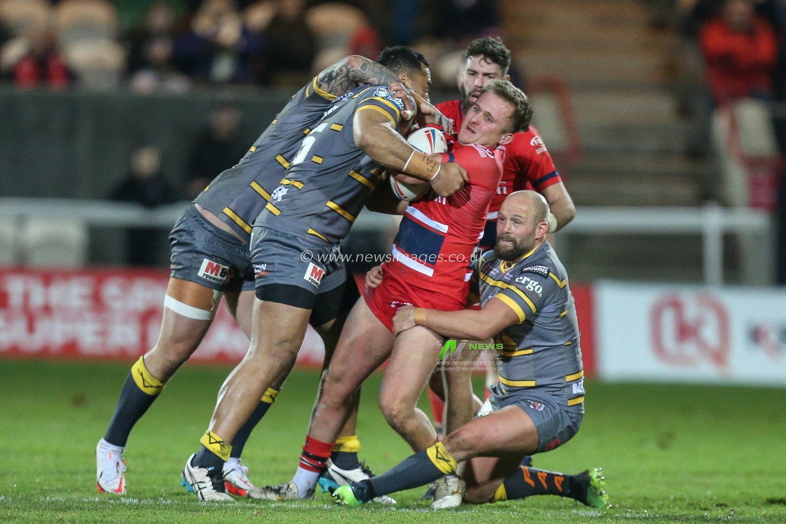 Jez Litten #14 of Hull KR is stopped by the Castleford defence