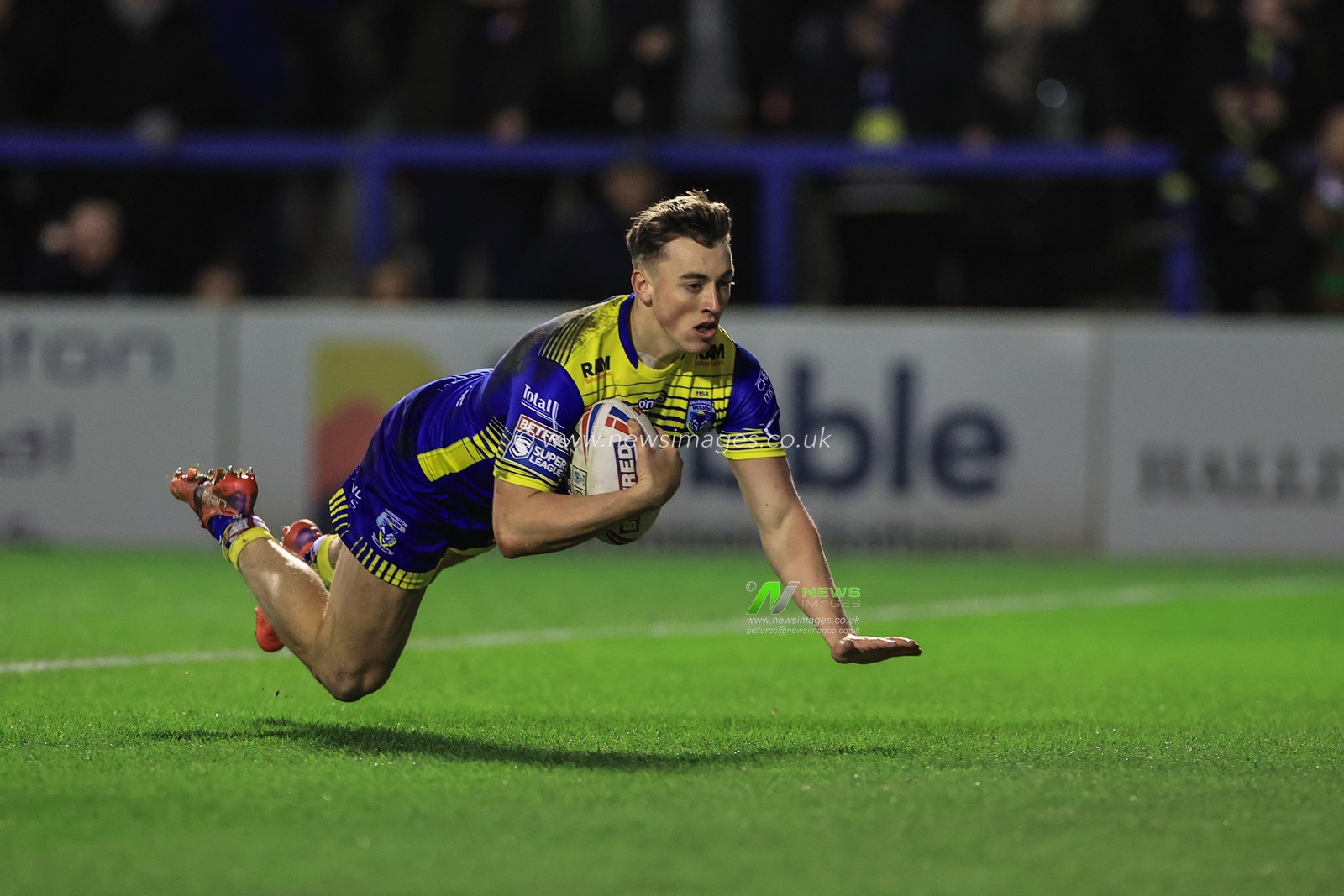 Matty Ashton #5 of Warrington Wolves makes a 60 yard solo dash to go over for a try