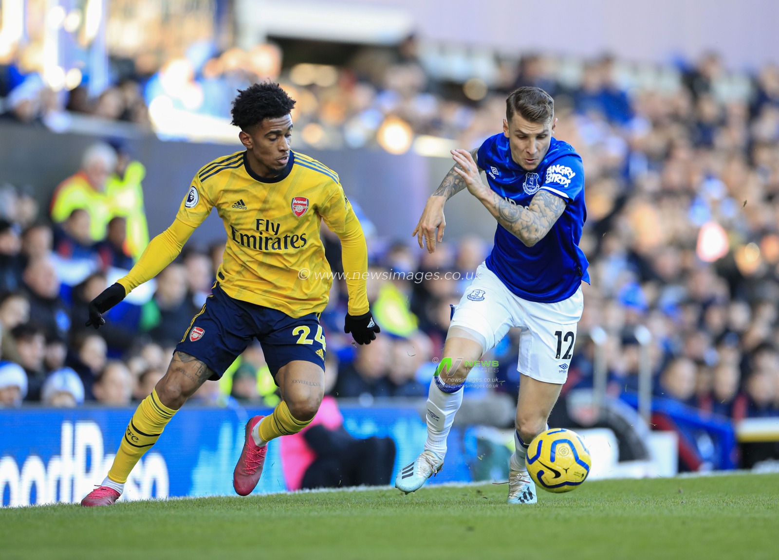 21st December 2019, Goodison Park, Liverpool, England; Premier League, Everton v Arsenal : Reiss Nelson (24) of Arsenal and Lucas Digne (12) of Everton challenge for the ball
Credit: Conor Molloy/News Images