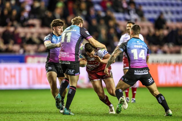 Ethan Havard of Wigan Warriors is tackled by Joe Batchelor of Hull FC and Cade Cust of Hull FC during the Betfred Super League match Wigan Warriors vs Hull FC at The Brick Community Stadium, Wigan, United Kingdom on 21 February 2026

(Photo by Alfie Cosgrove/News Images)