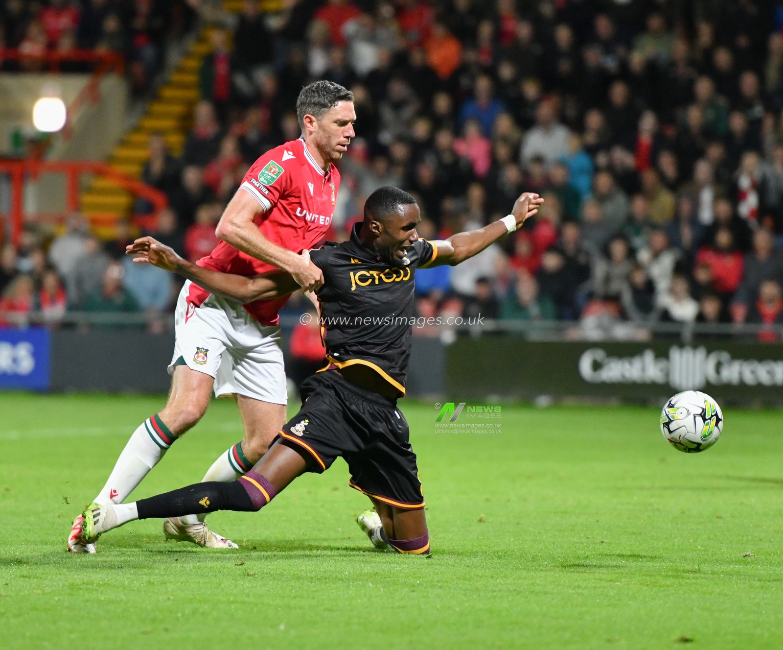 Wrexham's Ben Tozer fouls Bradfordâ€™s Emmanuel Osadebe, during the Carabao Cup match Wrexham vs Bradford City at The Racecourse Ground, Wrexham, United Kingdom, 29th August 2023

(Photo by Cody Froggatt/News Images)