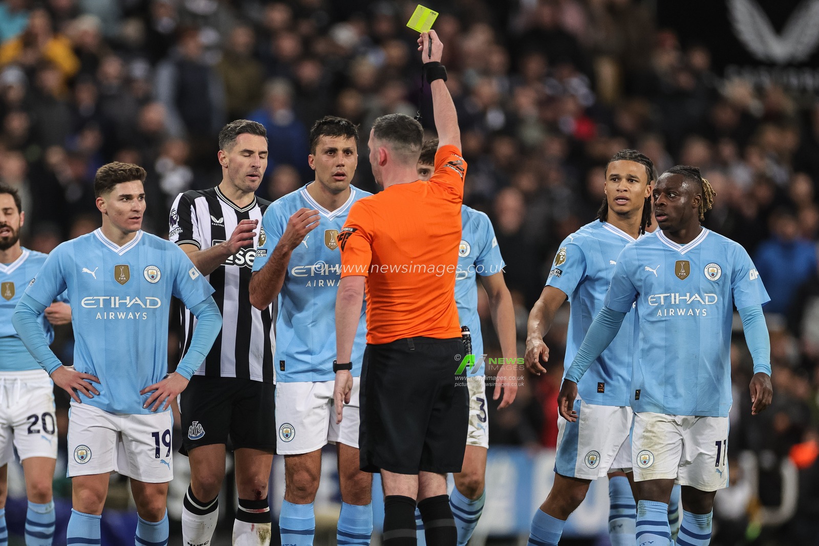 Rodri of Manchester City receives a yellow card from referee Chris Kavanagh  during the Premier League match Newcastle United vs Manchester City at St. James's Park, Newcastle, United Kingdom, 13th January 2024

(Photo by Mark Cosgrove/News Images)