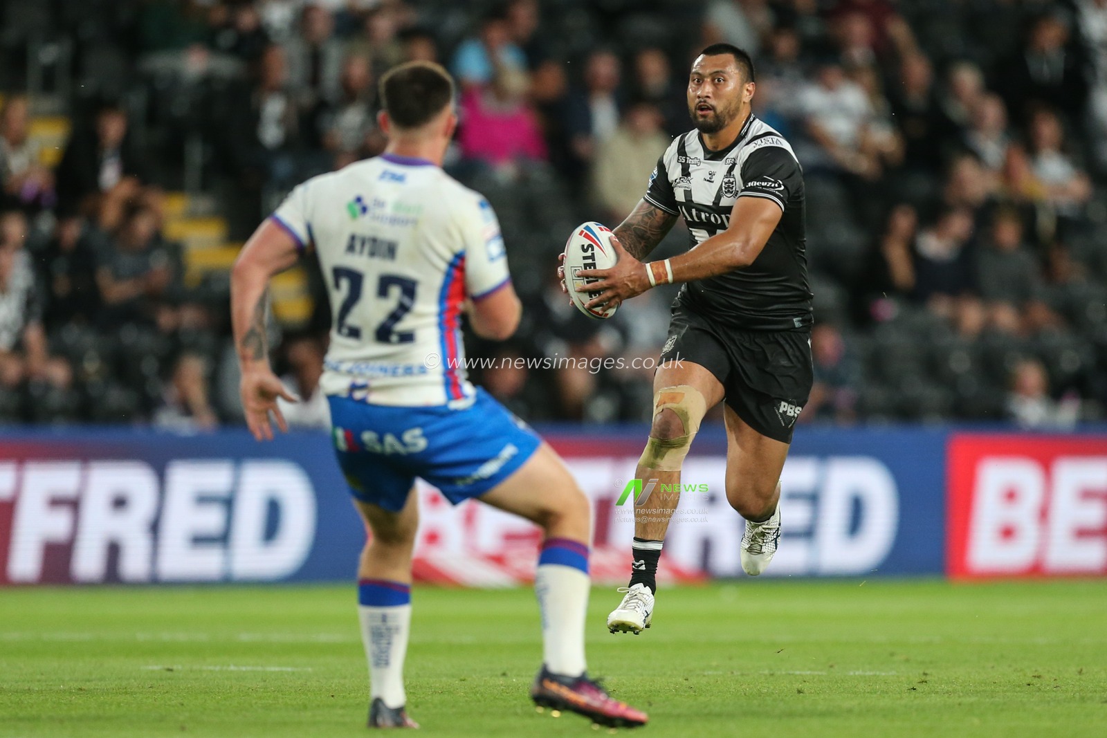 Ligi Sao #8 of Hull FC runs at Yusuf Aydin #22 of Wakefield Trinity