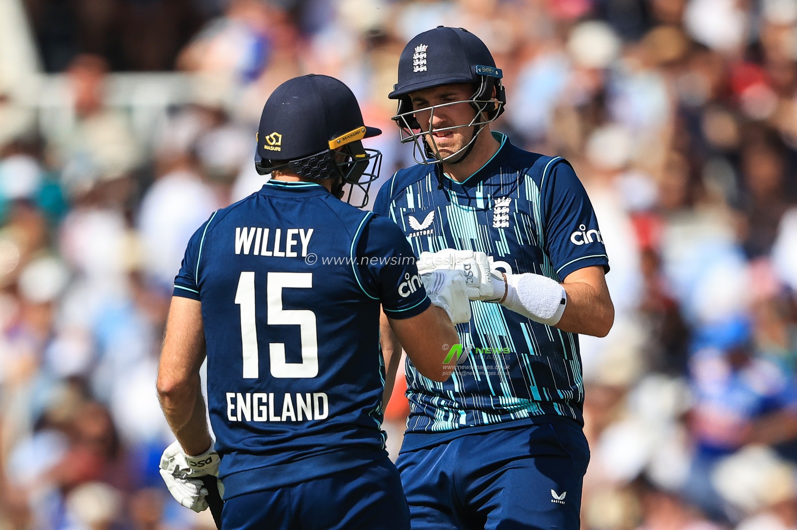 Craig Overton of England bumps with David Willey after he hits a 6