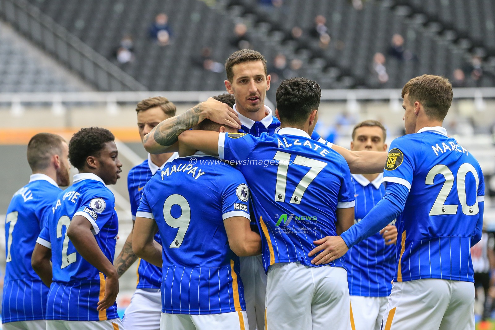 Neal Maupay (9) of Brighton and Hove Albion celebrates with his team mates after scoring from the penalty spot
