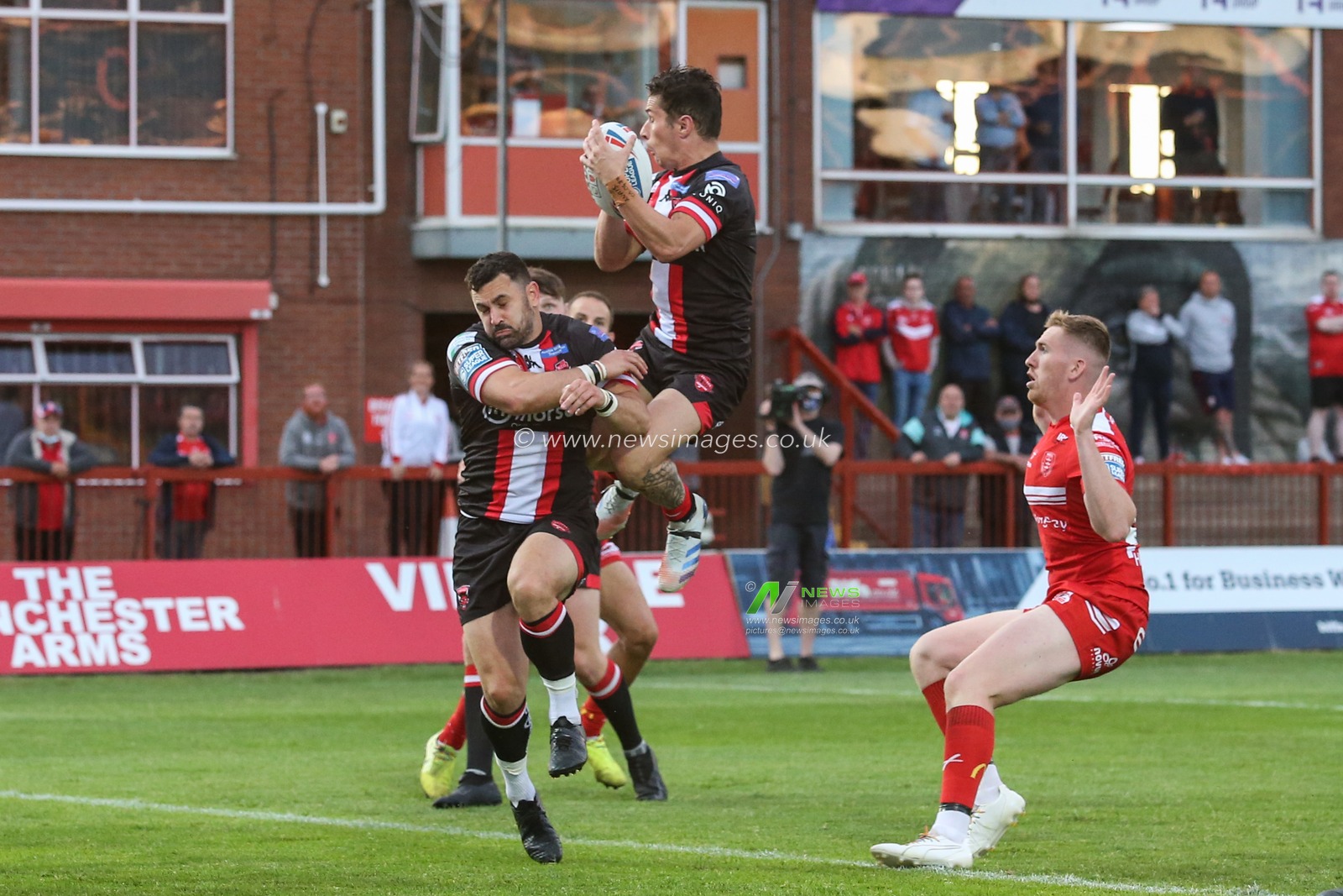 Morgan Escare (1) of Salford Red Devils gets up high to collect the ball