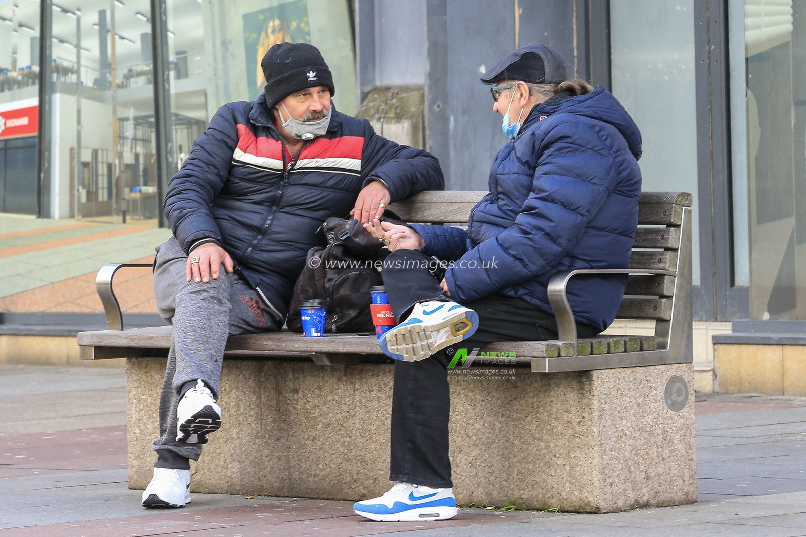 Two people talking outside of the Bridges Shopping Centre during Day One of Covid-19 national lockdown 2 on the streets of Sunderland City Centre