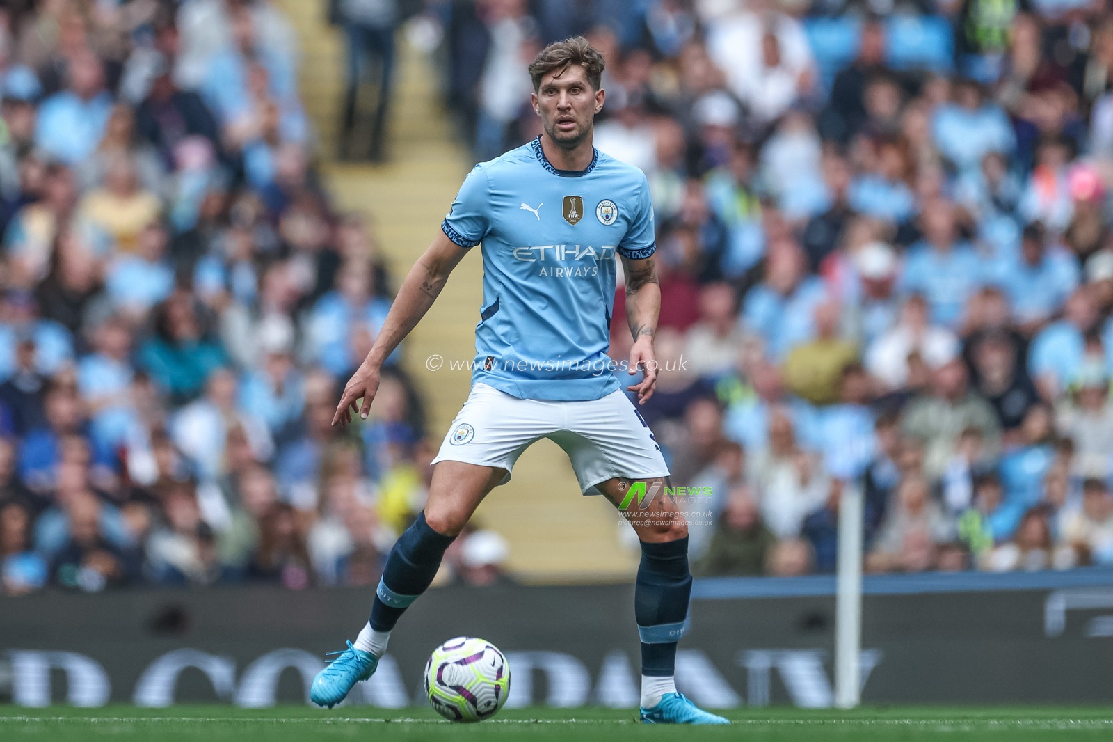 John Stones of Manchester City with the ball during the Premier League match Manchester City vs Brentford at Etihad Stadium, Manchester, United Kingdom, 14th September 2024

(Photo by Mark Cosgrove/News Images)