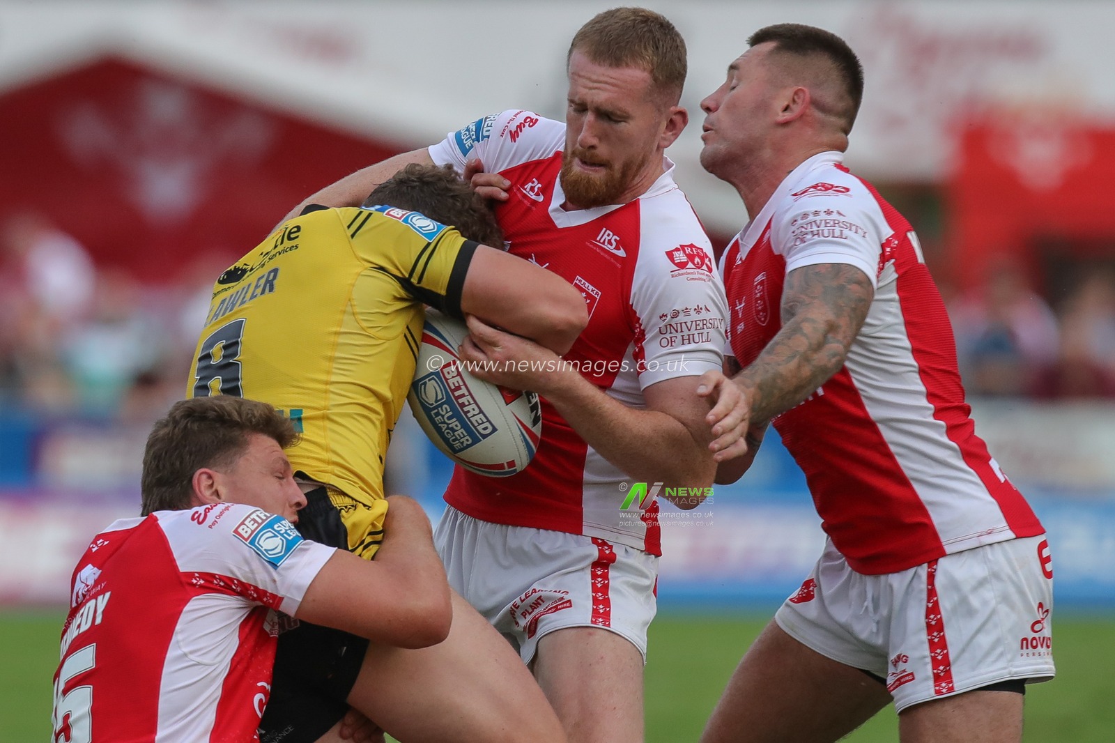 George Lawler #8 of Castleford Tigers is tackled by Rowan Milnes #21 of Hull KR and Rhys Kennedy #15 of Hull KR during the Betfred Super League Round 20 match Hull KR vs Castleford Tigers at Sewell Group Craven Park, Kingston upon Hull, United Kingdom, 28th July 2023

(Photo by James Heaton/News Images)