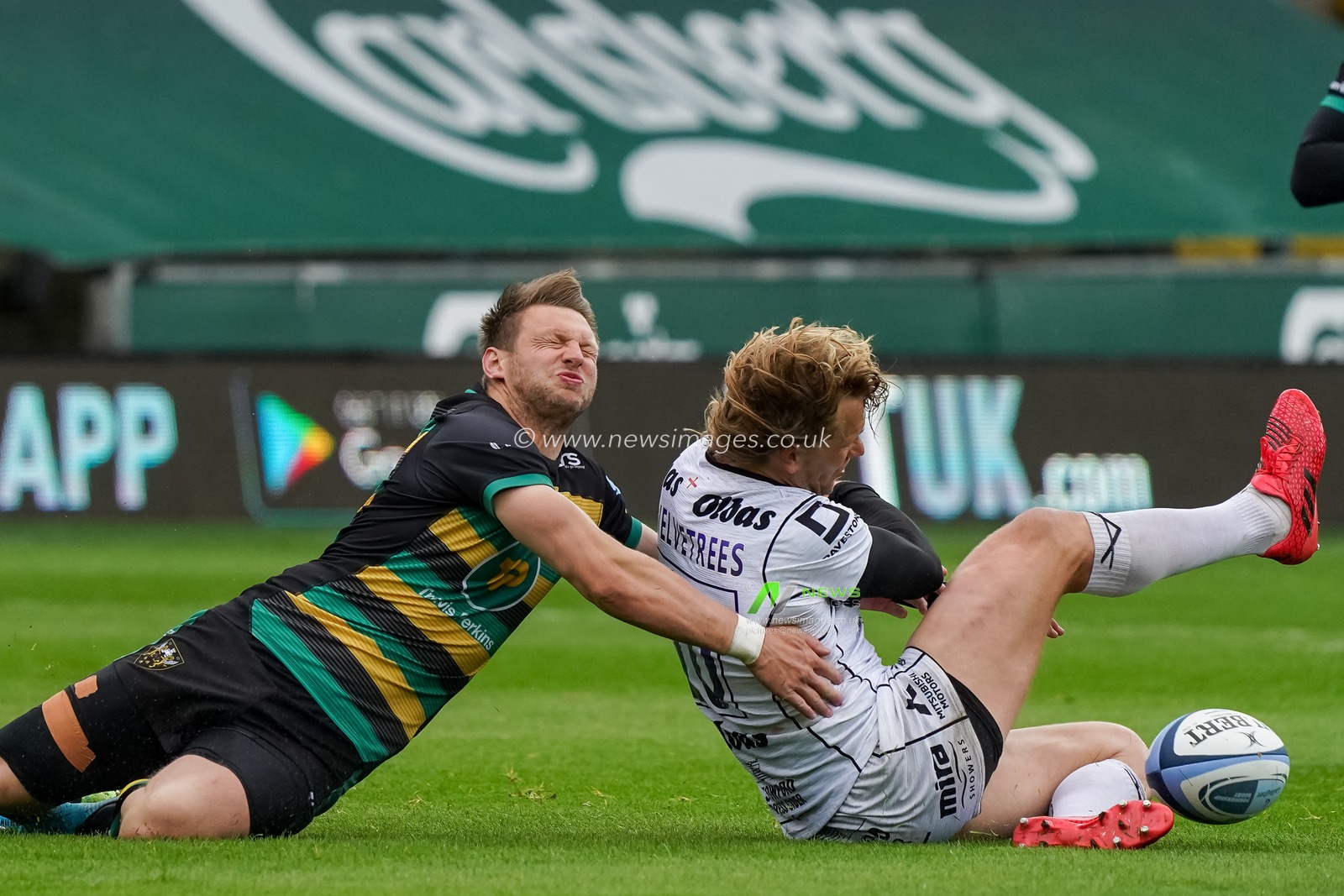 Dan Biggar #10 of Northampton Saints is caught by  Billy Twelvetrees #10 of Gloucester Rugby in a crunching tackle
