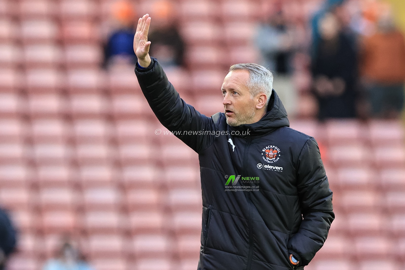 Neil Critchley head coach of Blackpool waves to the directors box