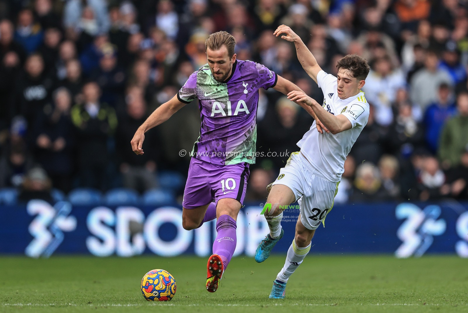 Harry Kane #10 of Tottenham Hotspur holds off Daniel James #20 of Leeds United