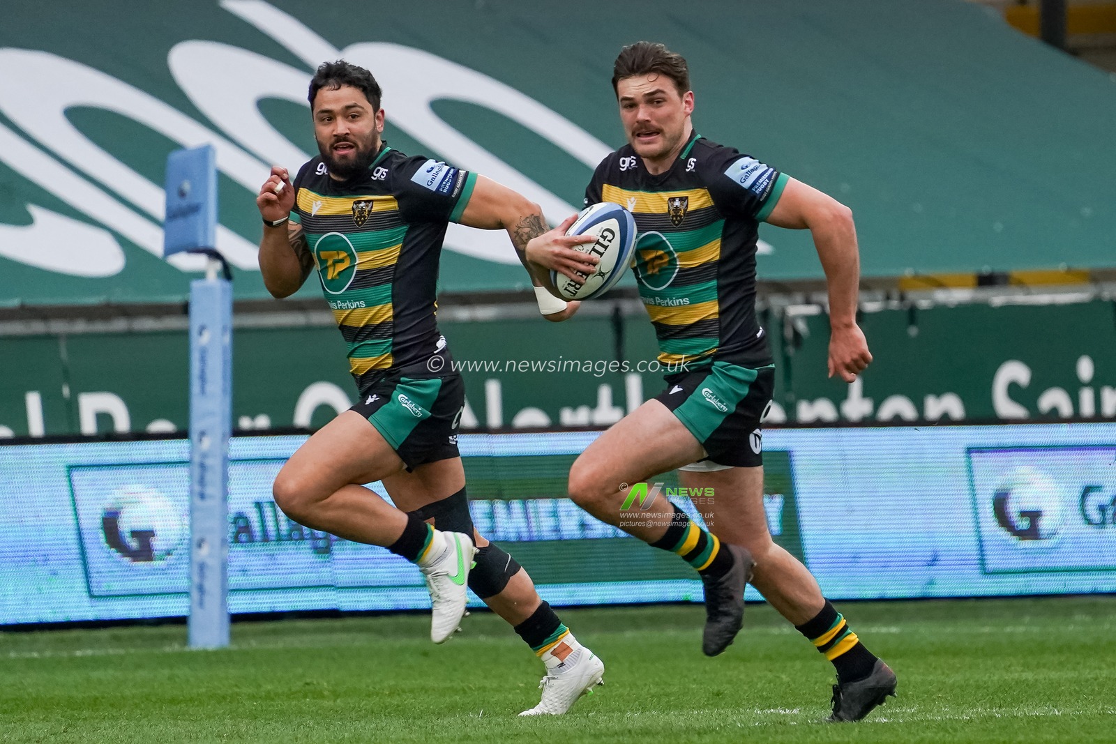 George Furbank #15 of Northampton Saints and  Matt Protor #14 of Northampton Saints race to the line