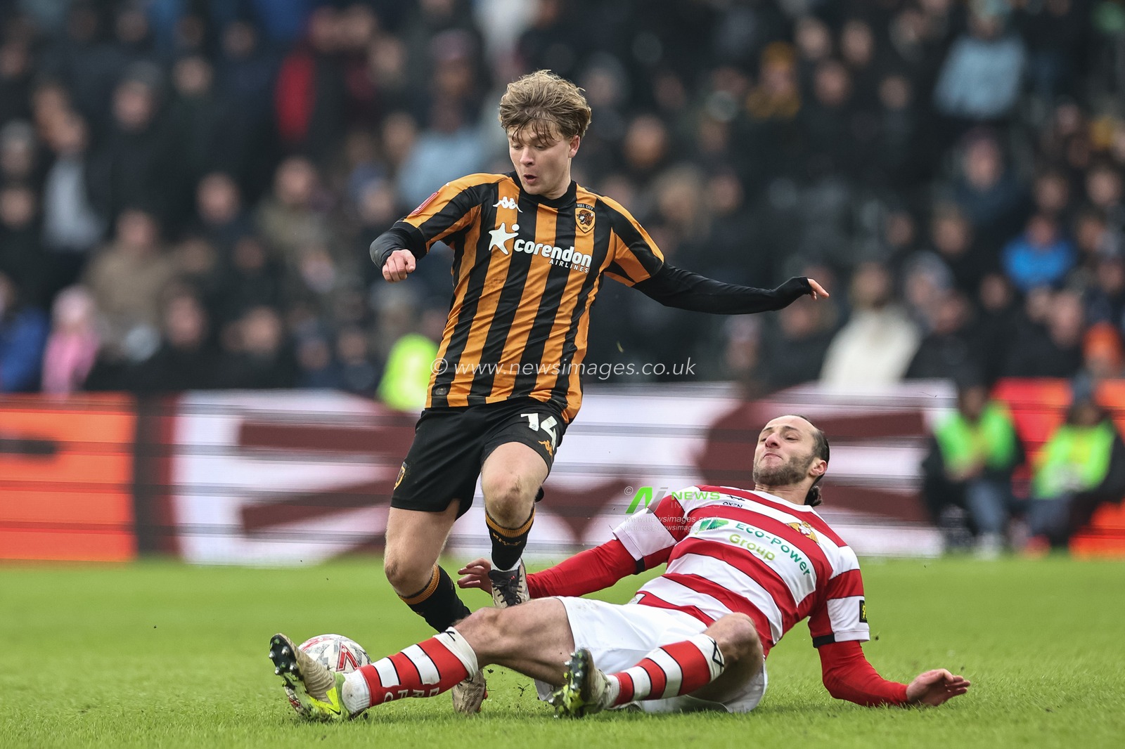 Jamie Sterry of Doncaster Rovers slide tackles Harry Vaughan of Hull City during the Emirates FA Cup 3rd Round match Hull City vs Doncaster Rovers at MKM Stadium, Hull, United Kingdom, 12th January 2025

(Photo by Mark Cosgrove/News Images)