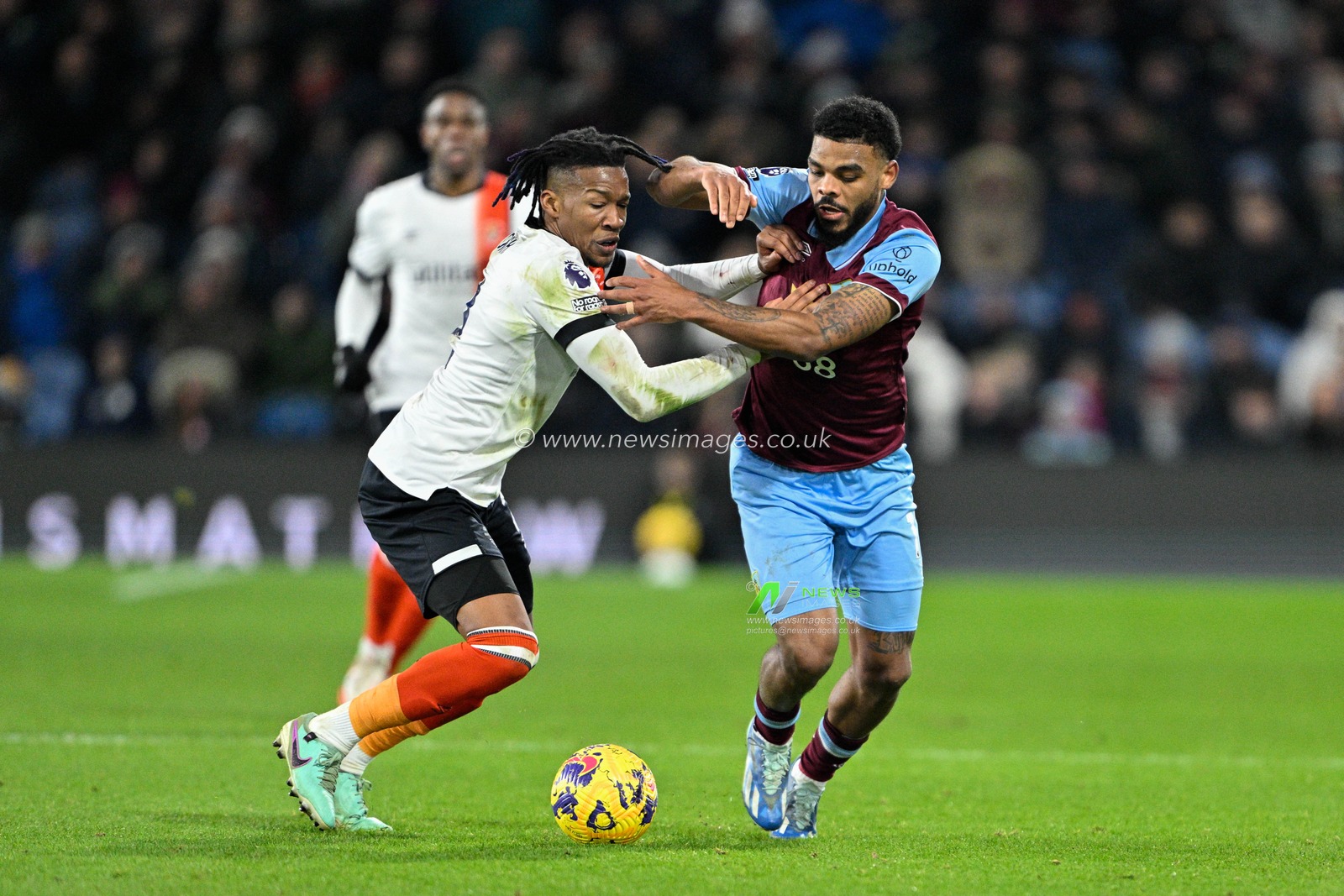 Gabriel Osho of Luton Town and Lyle Foster of Burnley battle for the ball during the Premier League match Burnley vs Luton Town at Turf Moor, Burnley, United Kingdom, 12th January 2024

(Photo by Cody Froggatt/News Images)