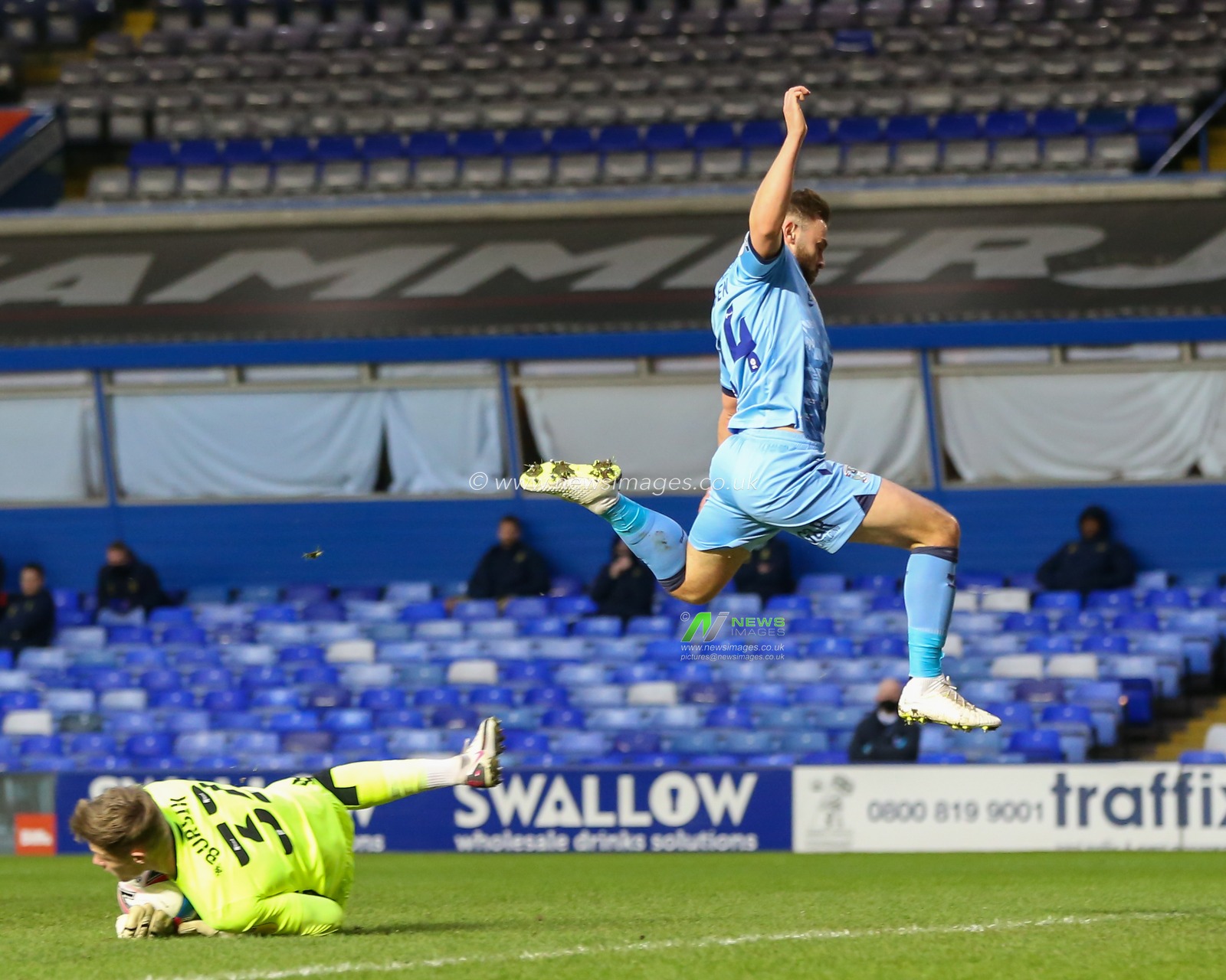 Josef Bursik #32 of Stoke City grabs the ball as Matthew Godden #24 of Coventry City flies over the top