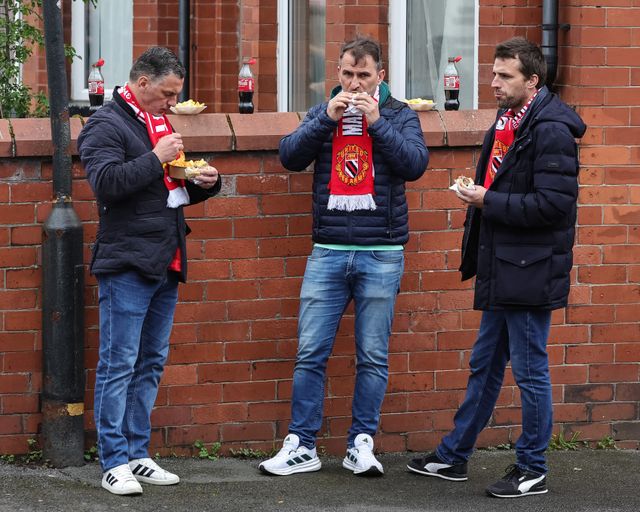 Manchester United fans grabbing a bite to eat on their way to the game during the Premier League match Manchester United vs Liverpool at Old Trafford, Manchester, United Kingdom on 03 May 2026

(Photo by Mark Cosgrove/News Images)