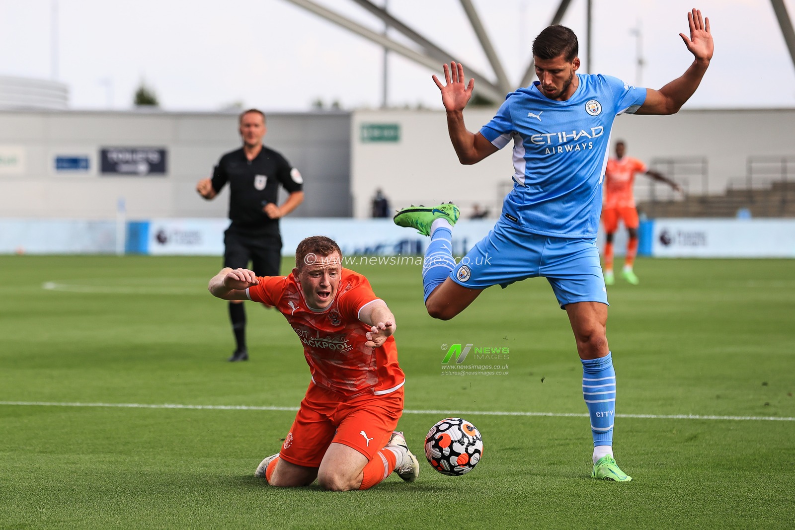 Ruben Dias #3 of Manchester City bring down Shayne Lavery of Blackpool for a penalty